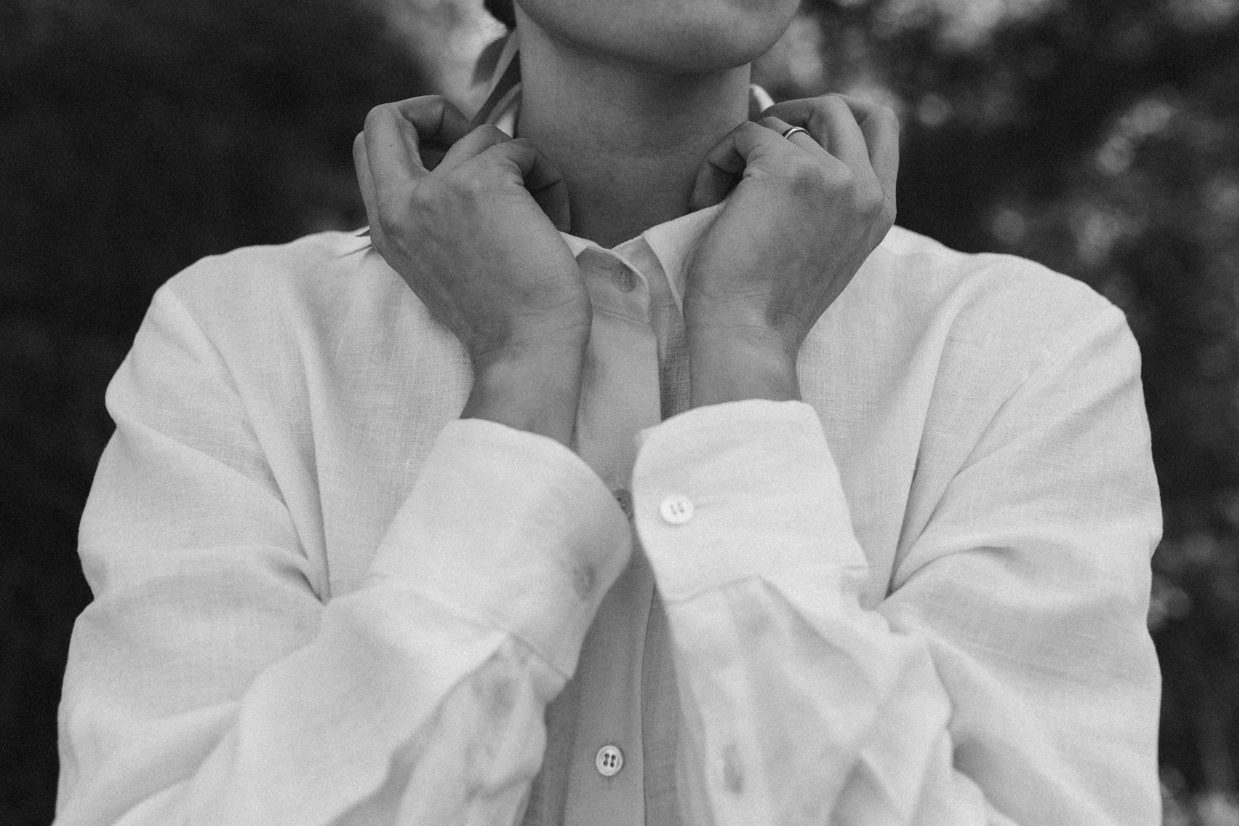 Black and white photo of woman in white button down shirt
