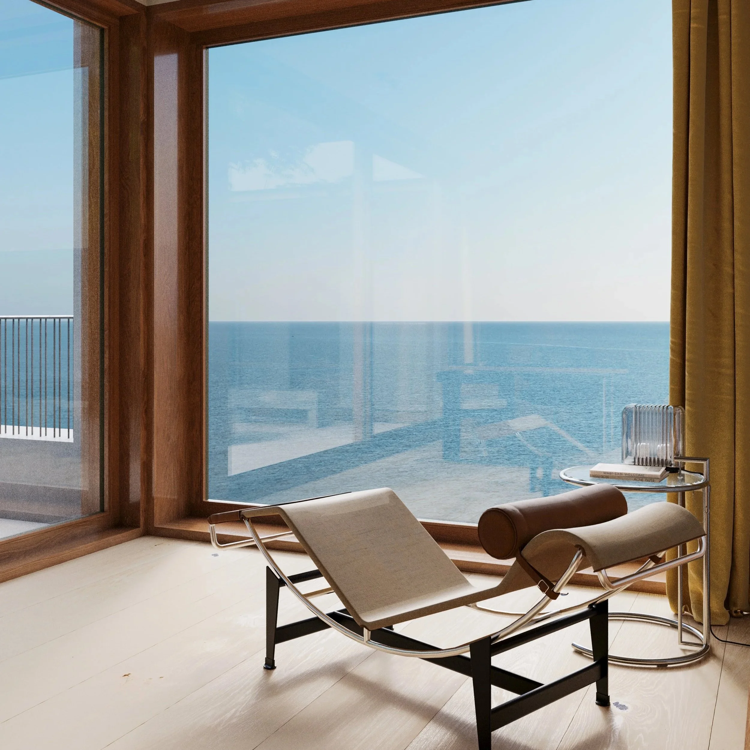 A modern room with a large window showing an ocean view, a Le Corbusier lounge chair, and an Eileen Gray side table with a glass light and a book.