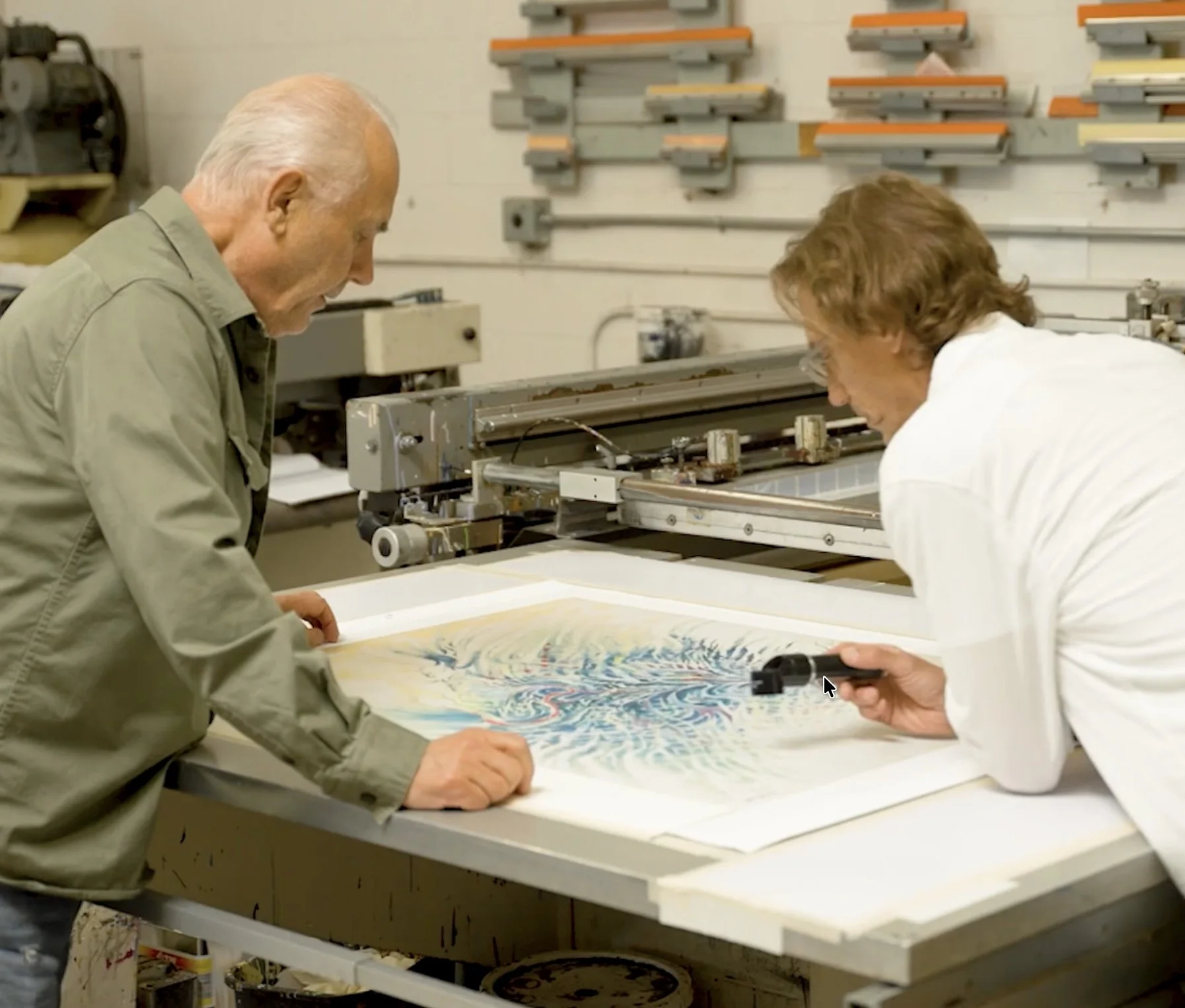 Kolibri Art Studio printers registering a sheet on the press during a Dr. Seuss edition run.
