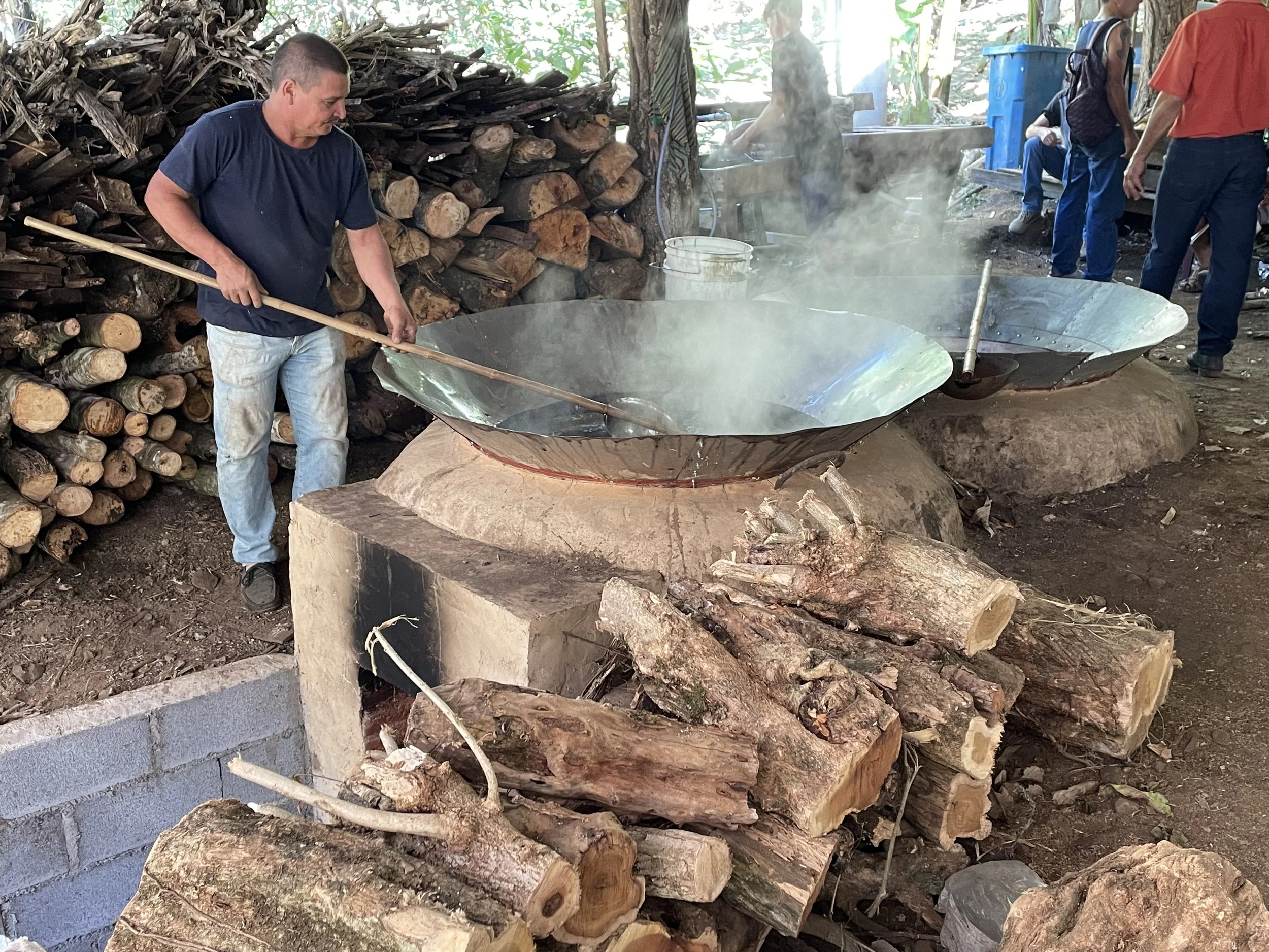 A man cooks down sugar cane juice in a traditional costa rican trapiche