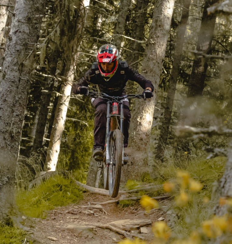 Mountain biker pumps through the trees at La Lucha Farm Costa Rica.