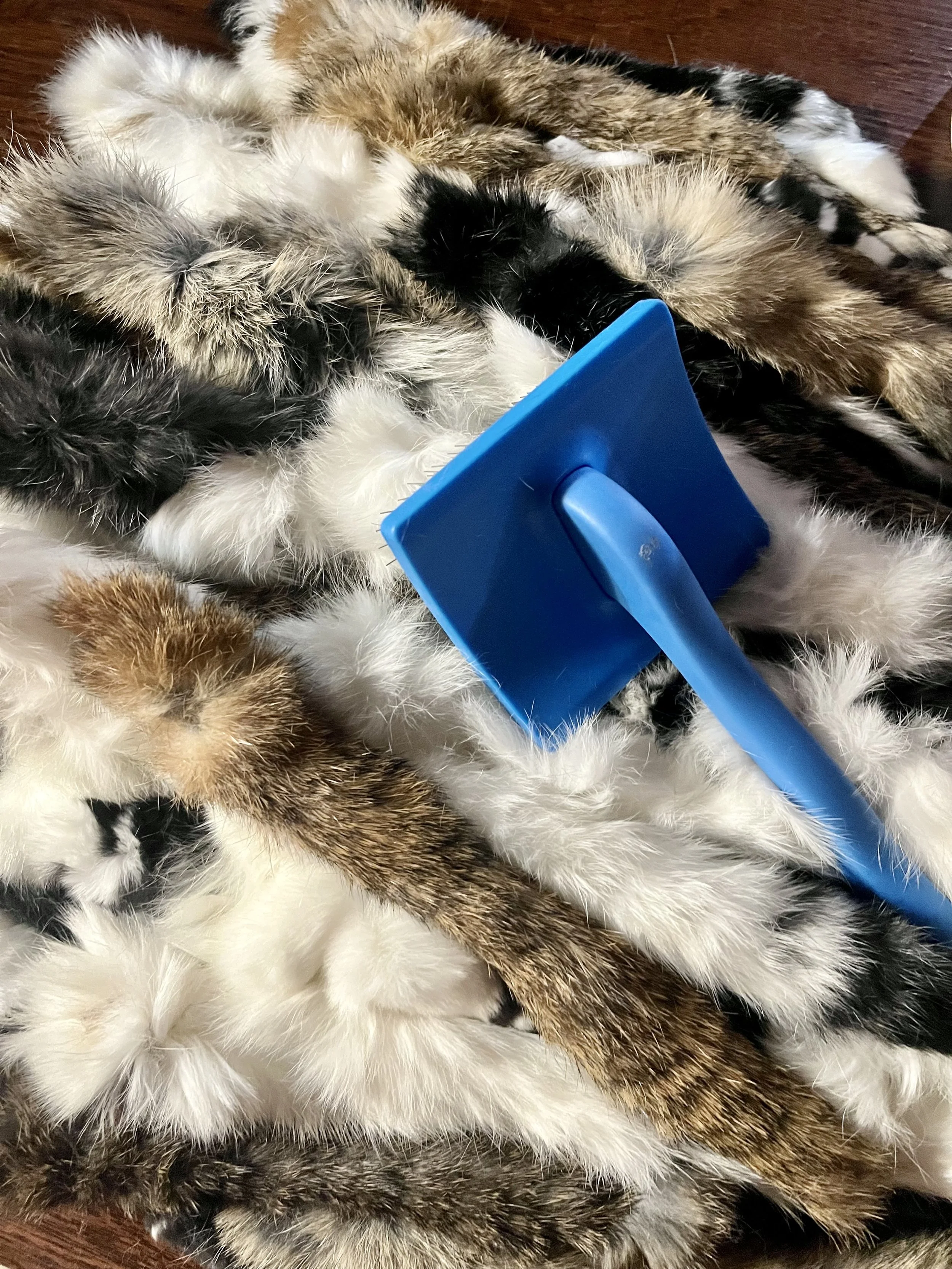 Rabbit hide strips being brushed and prepared by hand at H&N Homestead