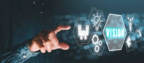 A person's hand interacting with holographic icons and the word 'vision', representing technology or innovation.