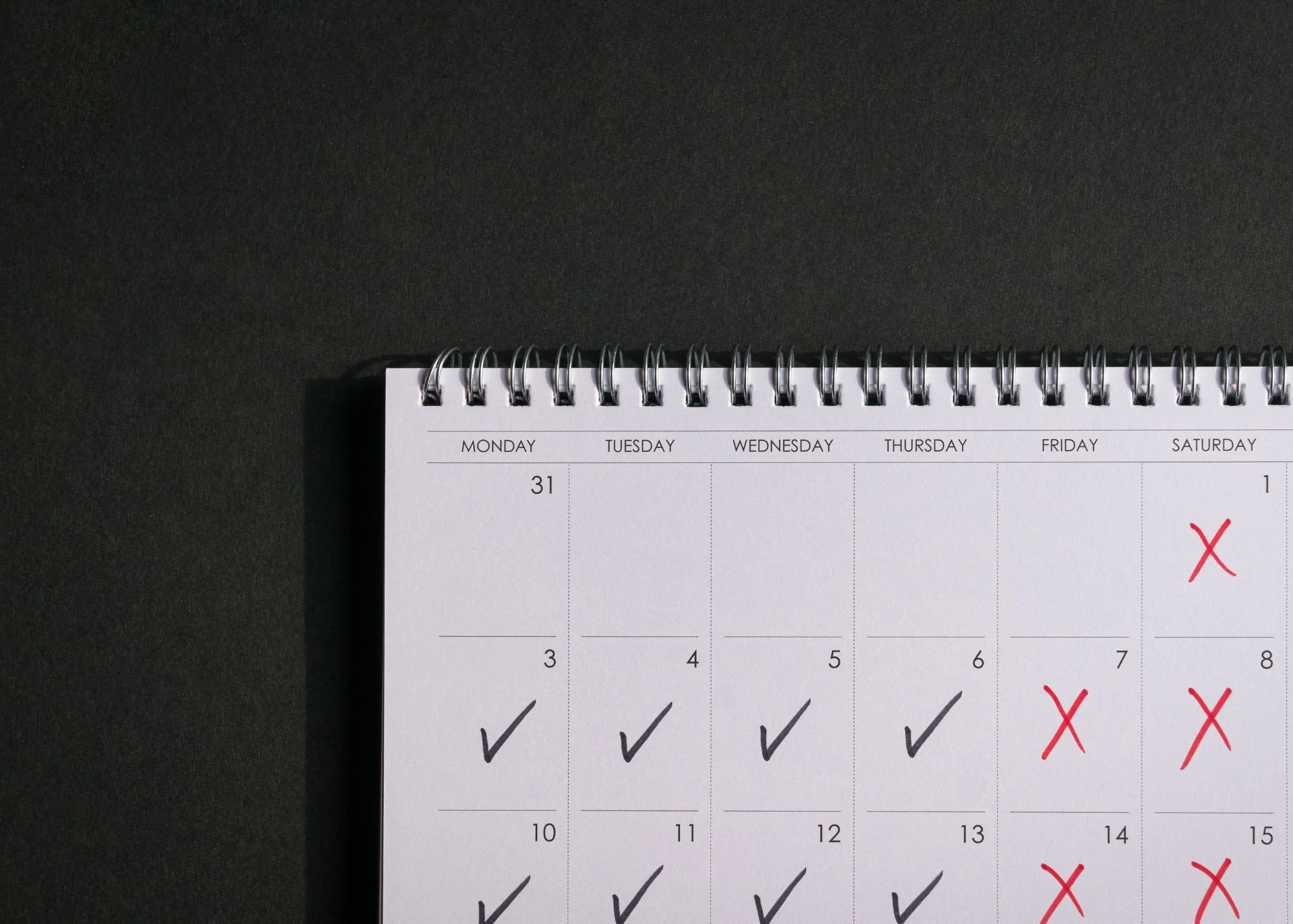Simple consistent habits recorded on a calendar that support weight loss for women over 40.