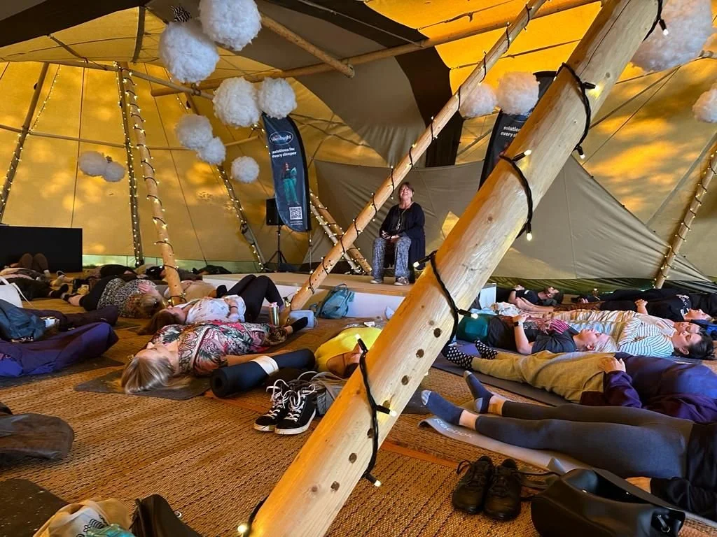 People lying down and being guided in an EcoNIDRA session By Maria of Mindful Connections