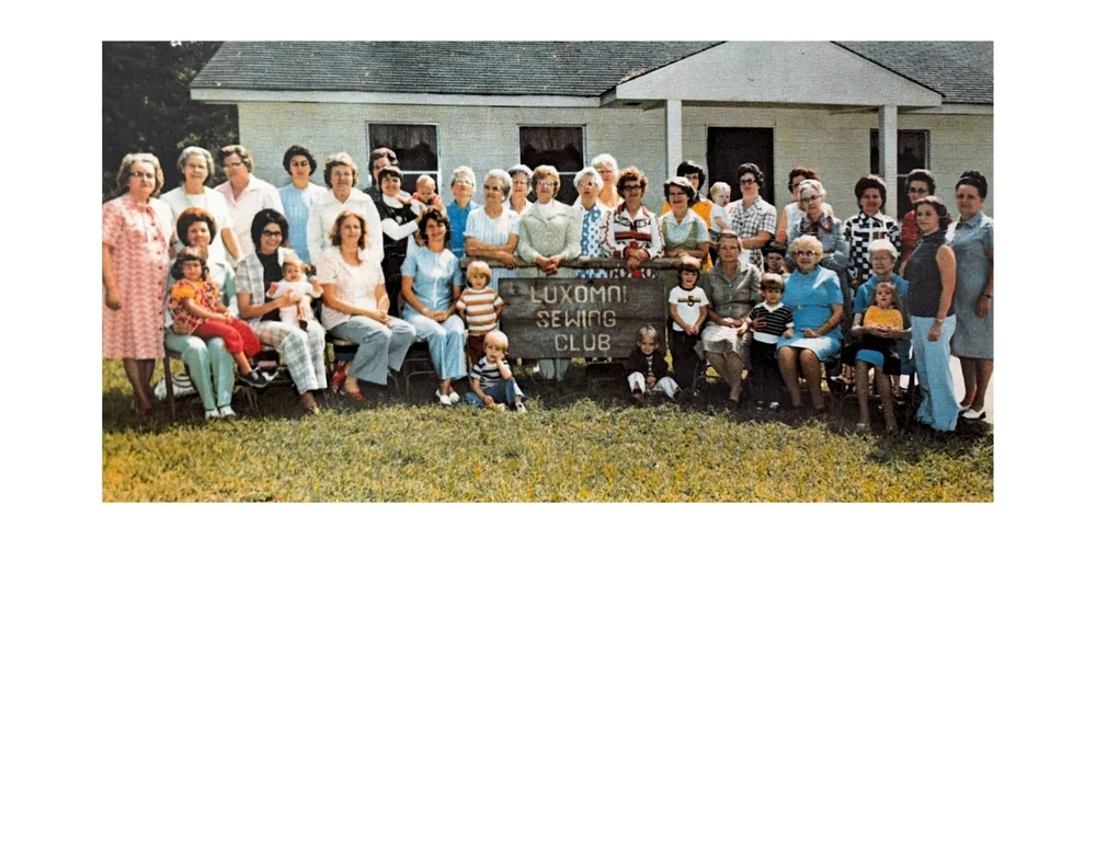 Luxomni Sewing Club members and families gathered outside the club building