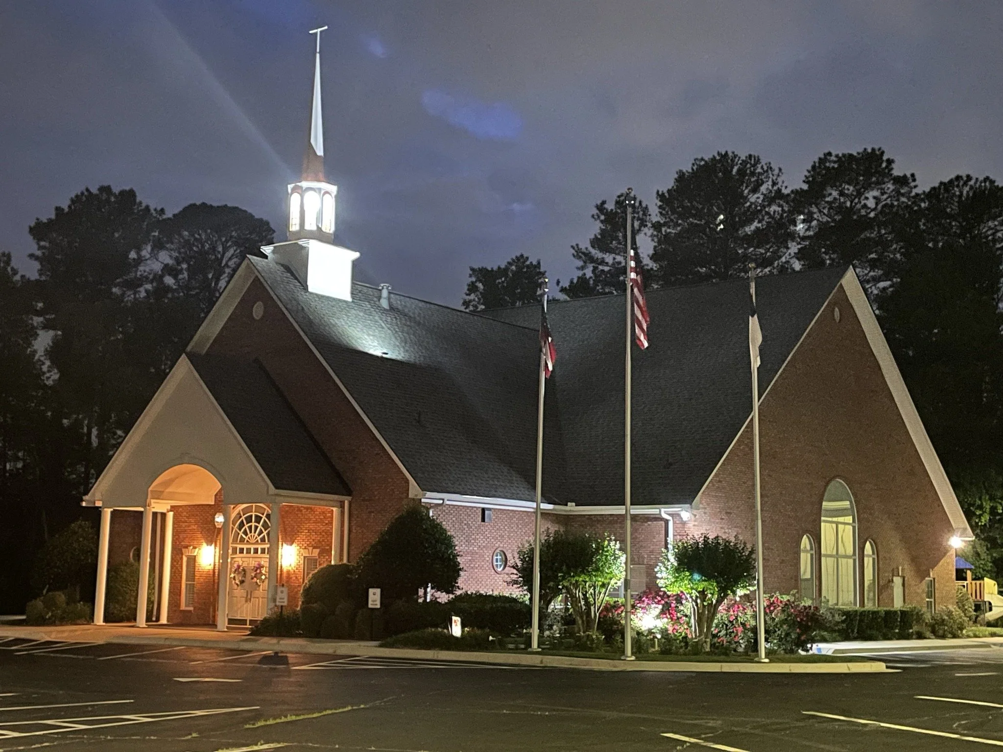 The brick Luxomni Church building at night