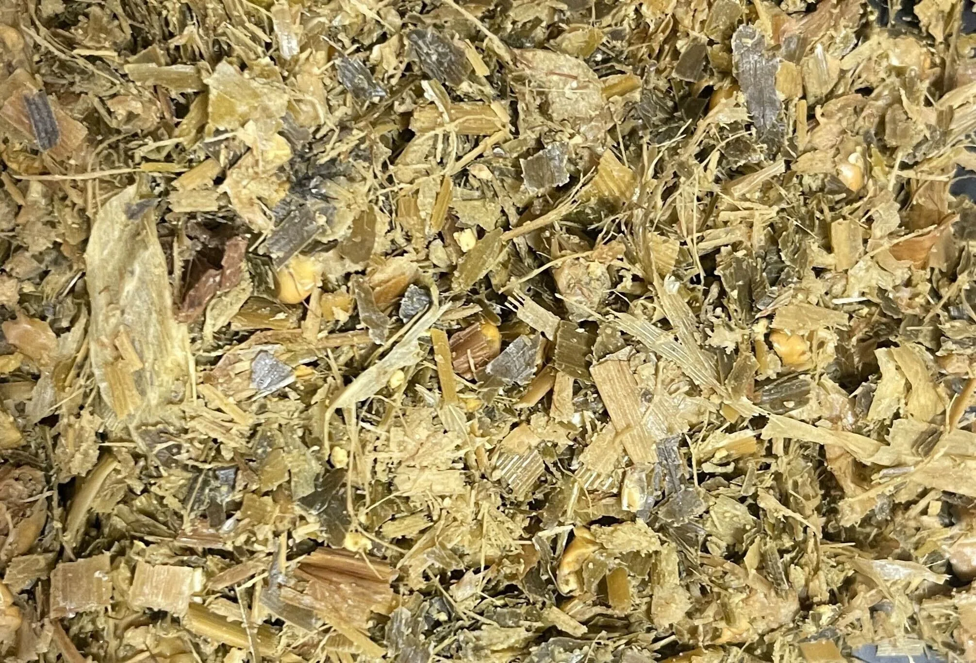 Close-up view of shredded herbal plant material, possibly tea leaves or dried herbs.