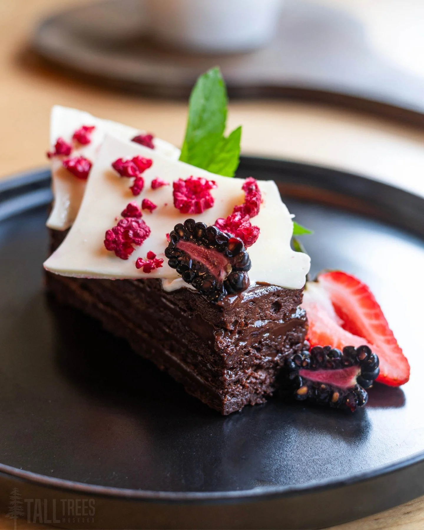 Our Flourless Dark Chocolate Grand Marnier Torte challenges everything you think you know about gluten-free desserts. 

This bittersweet chocolate cake, layered with silky ganache, is rich, moist, and delicious. We serve it alongside a classic raspbe