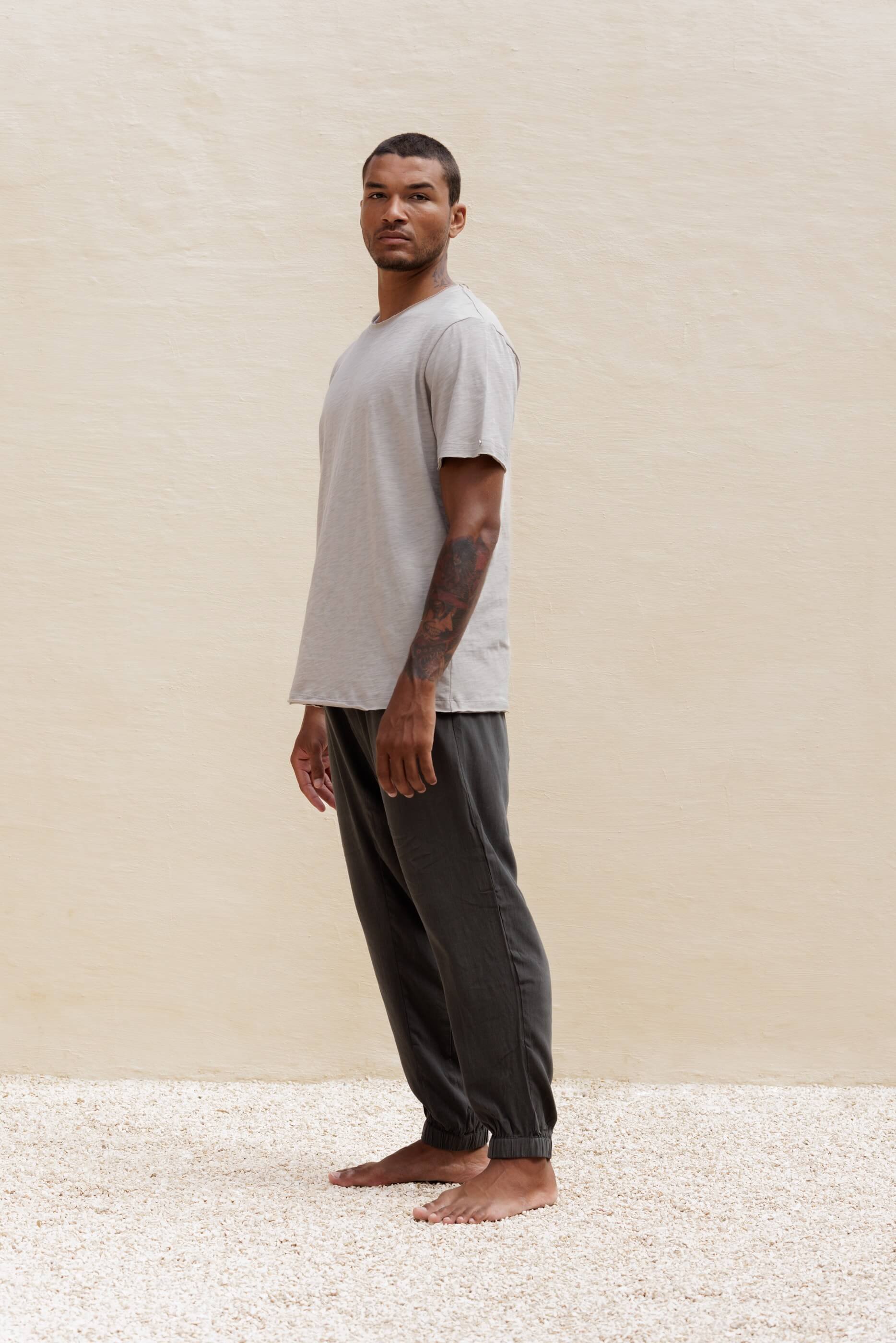 Full-length side view of a model in the Gracio trousers outfit, demonstrating the distinct central seam and sophisticated play of movement.