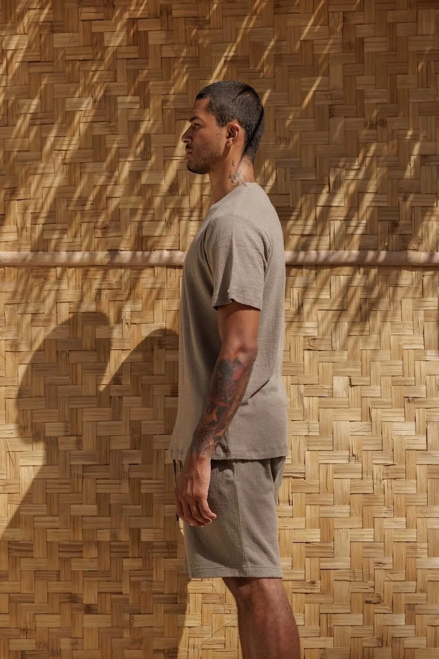 Side profile view of NOUSA Victor t-shirt and matching shorts in Ocean Fog green-grey linen-cotton jersey, highlighting the relaxed fit.