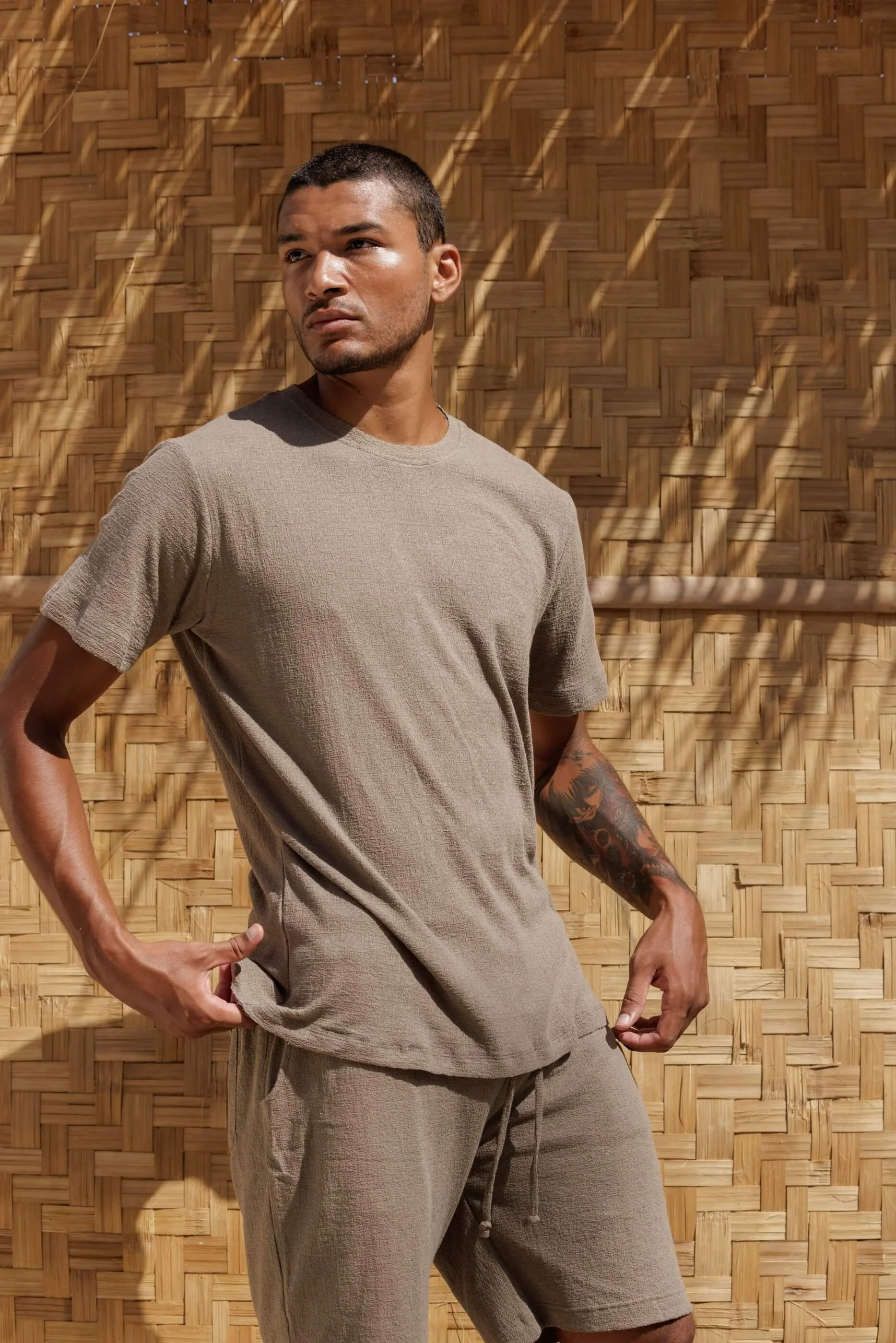 Man wearing NOUSA Victor men's premium t-shirt in Ocean Fog green-grey linen-cotton jersey, three-quarter front view.