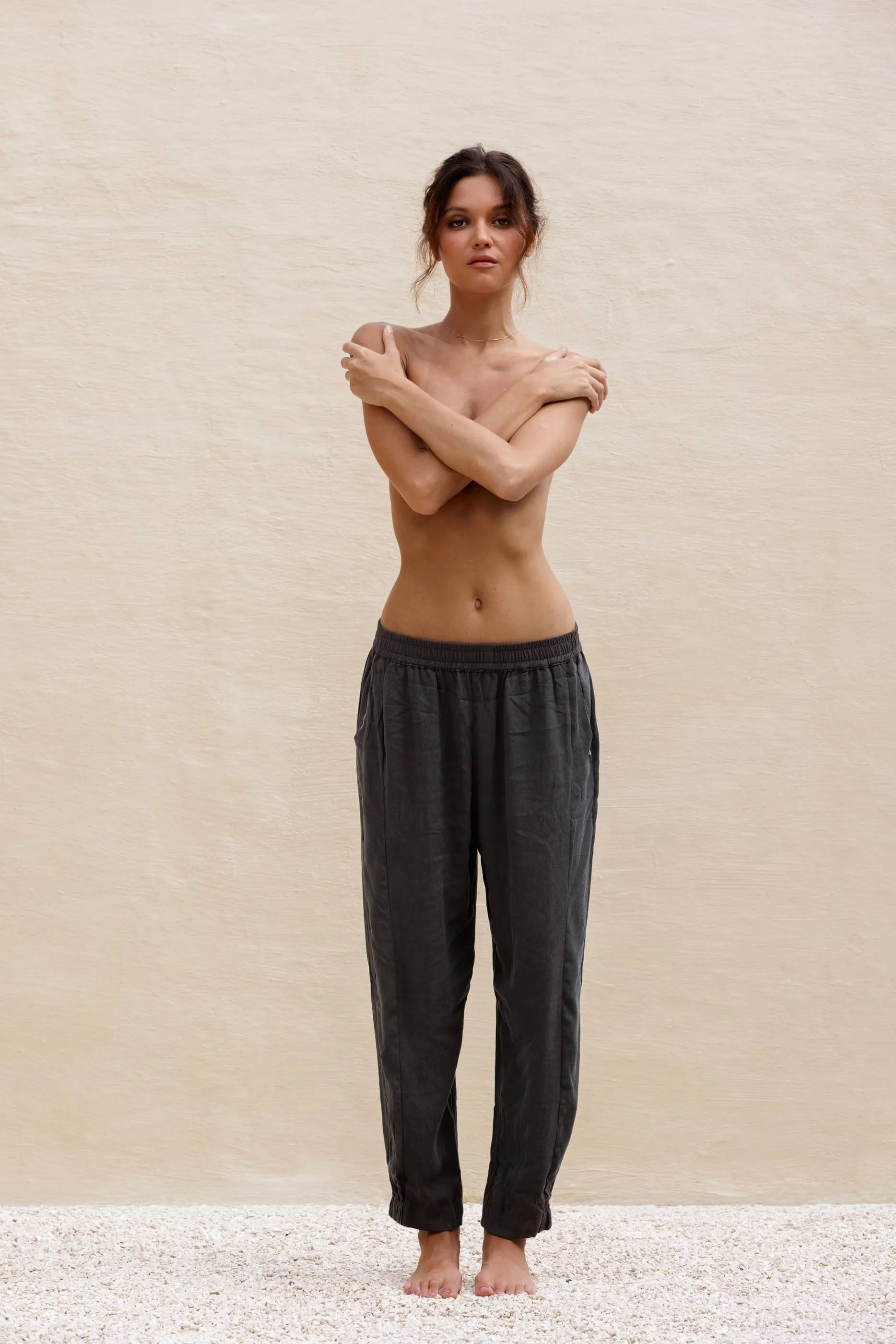 Full-length front view of a model wearing Olivera women's premium trousers in Dust Grey Tencel, showing the fluid drape and barrel silhouette.