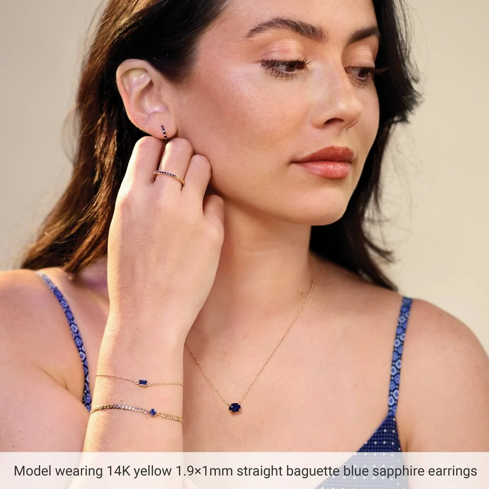 14k-yellow-gold-1-9x1mm-baguette-blue-sapphire-huggie-earrings-model.jpeg (Copy)