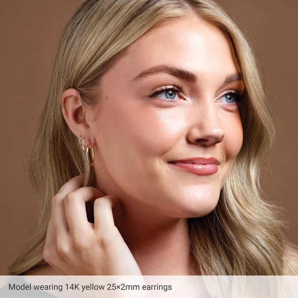 14k-yellow-gold-30mm-tube-hoop-earrings-on-model.jpeg