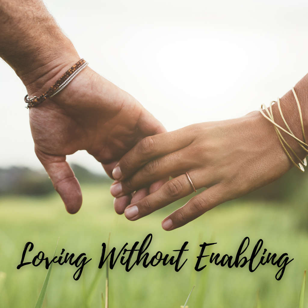 Two people gently holding hands, symbolizing connection and boundaries in a relationship affected by addiction, with the words “Loving Without Enabling” displayed below.