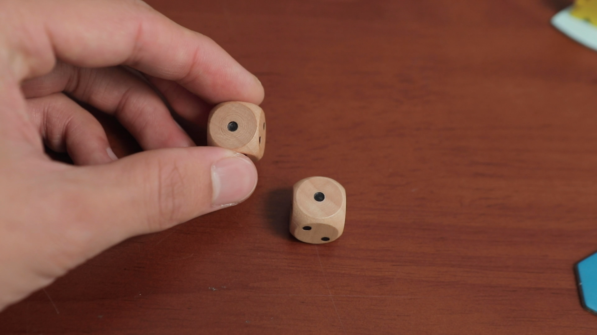 Simple wooden dice that are actually D3s, fuel the anxiety of GREED.