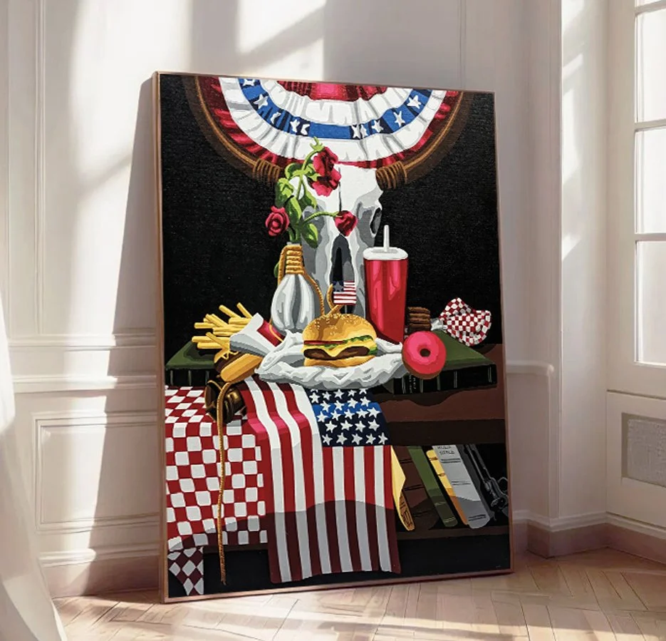 Painting of a patriotic American scene with a cow skull, red roses, American flag-themed food and decor, including fries, burger, soda, donut, and a checkered tablecloth in red, white, and blue, set on a table with a shelf underneath holding books.