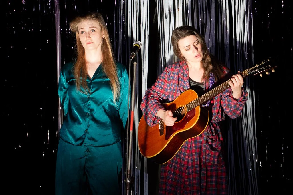 Sisters Jenny (Leah Strasser) and Kate (Erin Ward) were a locally famous singing duo as children, though their lives have both veered off course in the years since. [Photo by Diana Cárdenas]