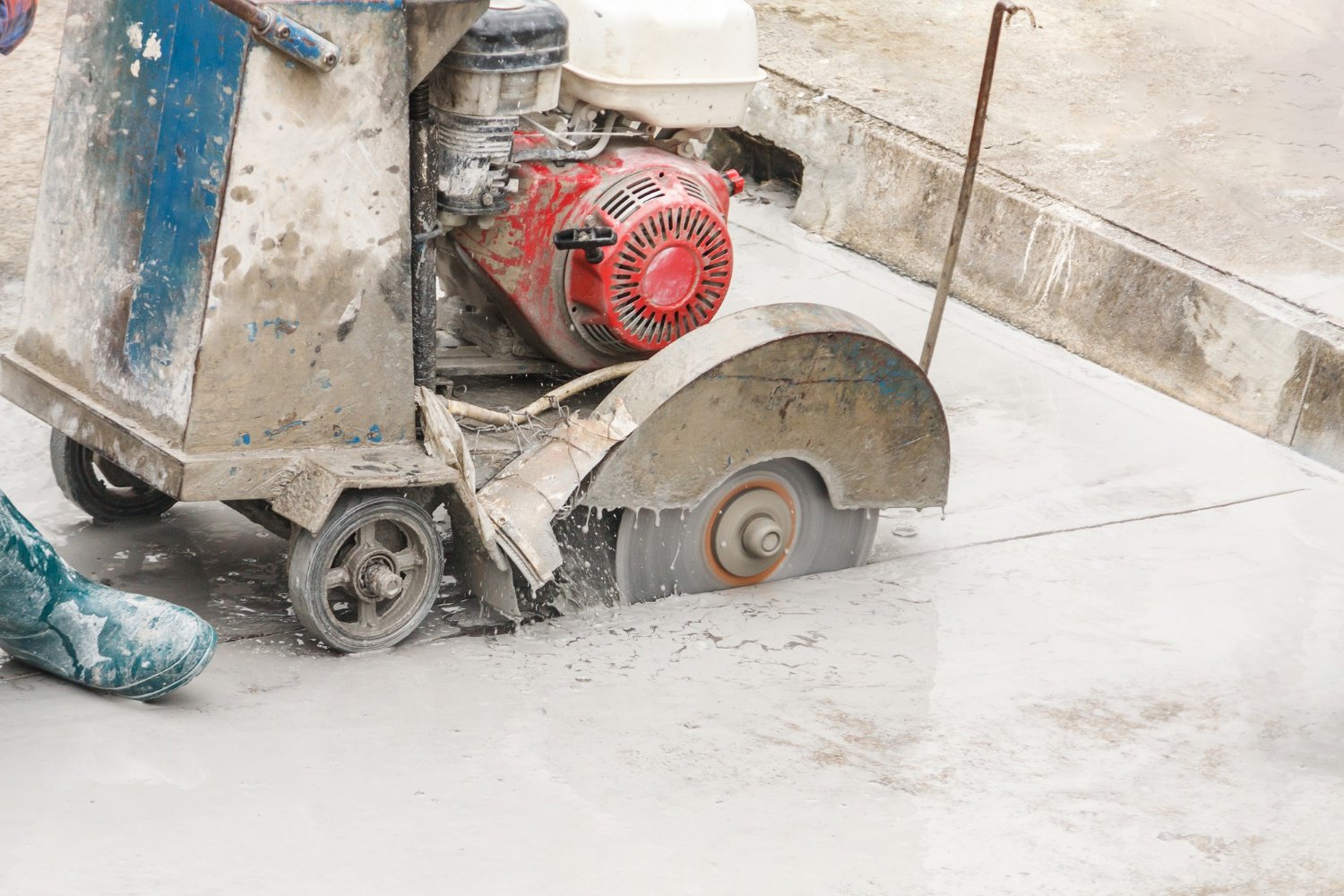 Technician operating concrete cutting equipment in Newcastle