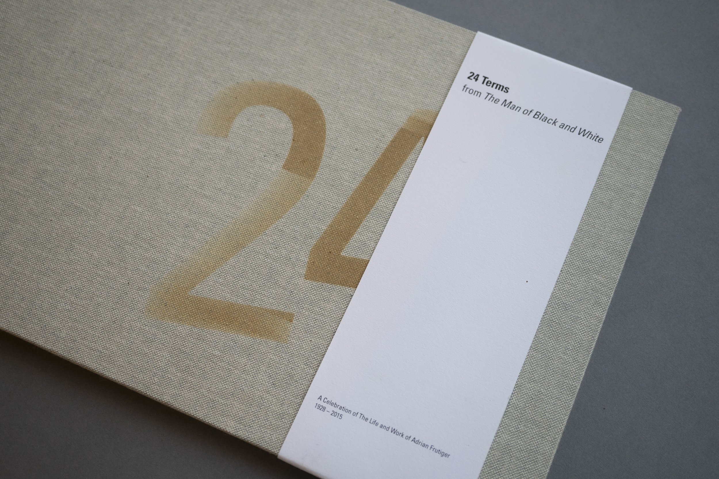 24 Terms from The Man of Black and White, Adrian Frutiger book cover showing the number twenty four etched on the front with a belly band.