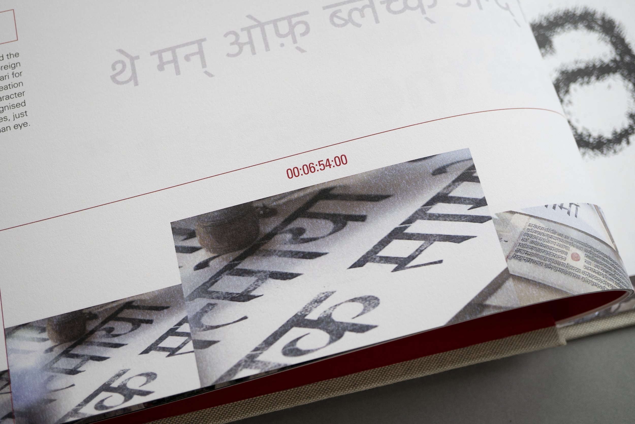 Close up photograph of a snippet from the film 'the Man of Black and White' hand-drawn Devanagari symbols produced by Adrian Frutiger.