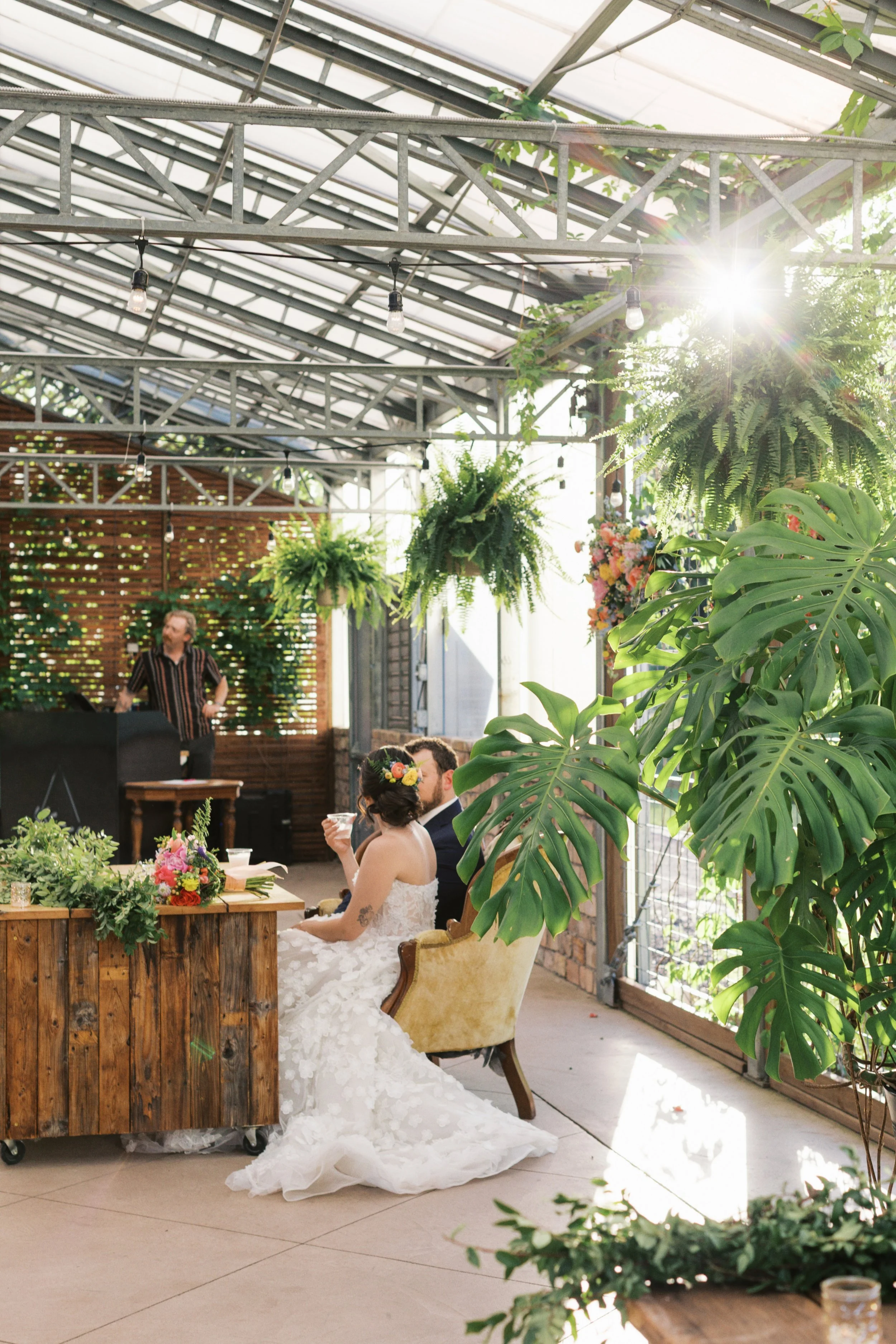 Inca Photography - Wedding & Elopement Photographer Based In Tennessee - Bride and groom standing on a lawn with greenery, the groom kissing the bride on the cheek.