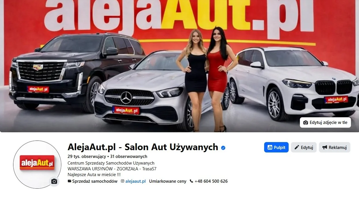 Two women standing between three cars in a dealership showroom, with a red and yellow background displaying the text 'alejaAut.pl'.