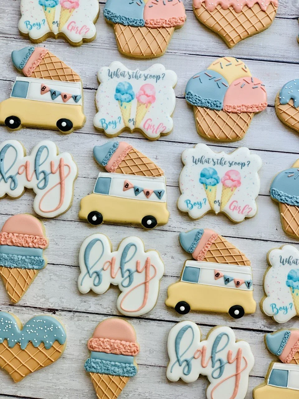 Gender reveal themed cookies with designs of ice cream cones, food trucks, and the words "What’s the scoop? Boy or Girl?" and "baby."