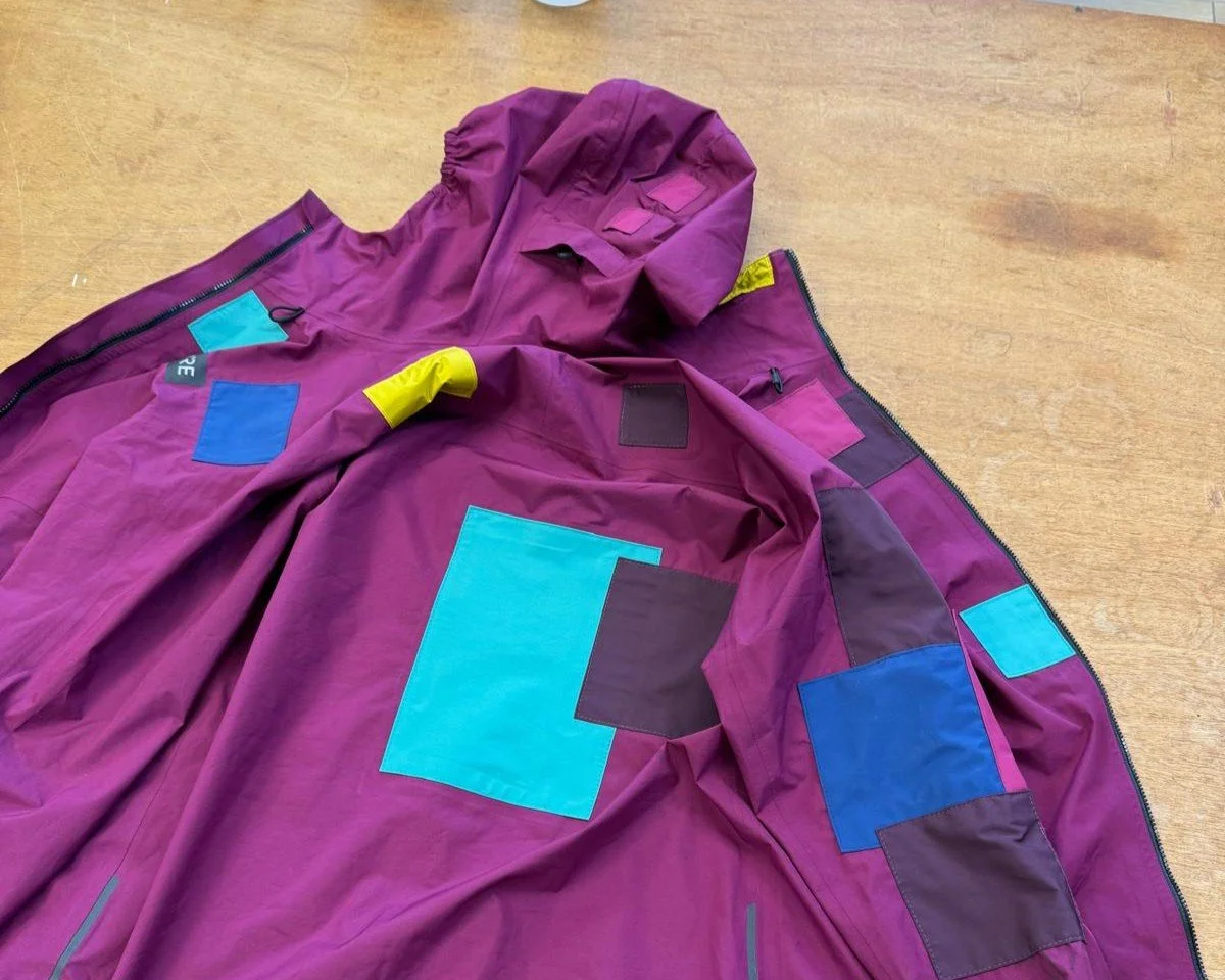 waterproof jacket with colourful patches all over it