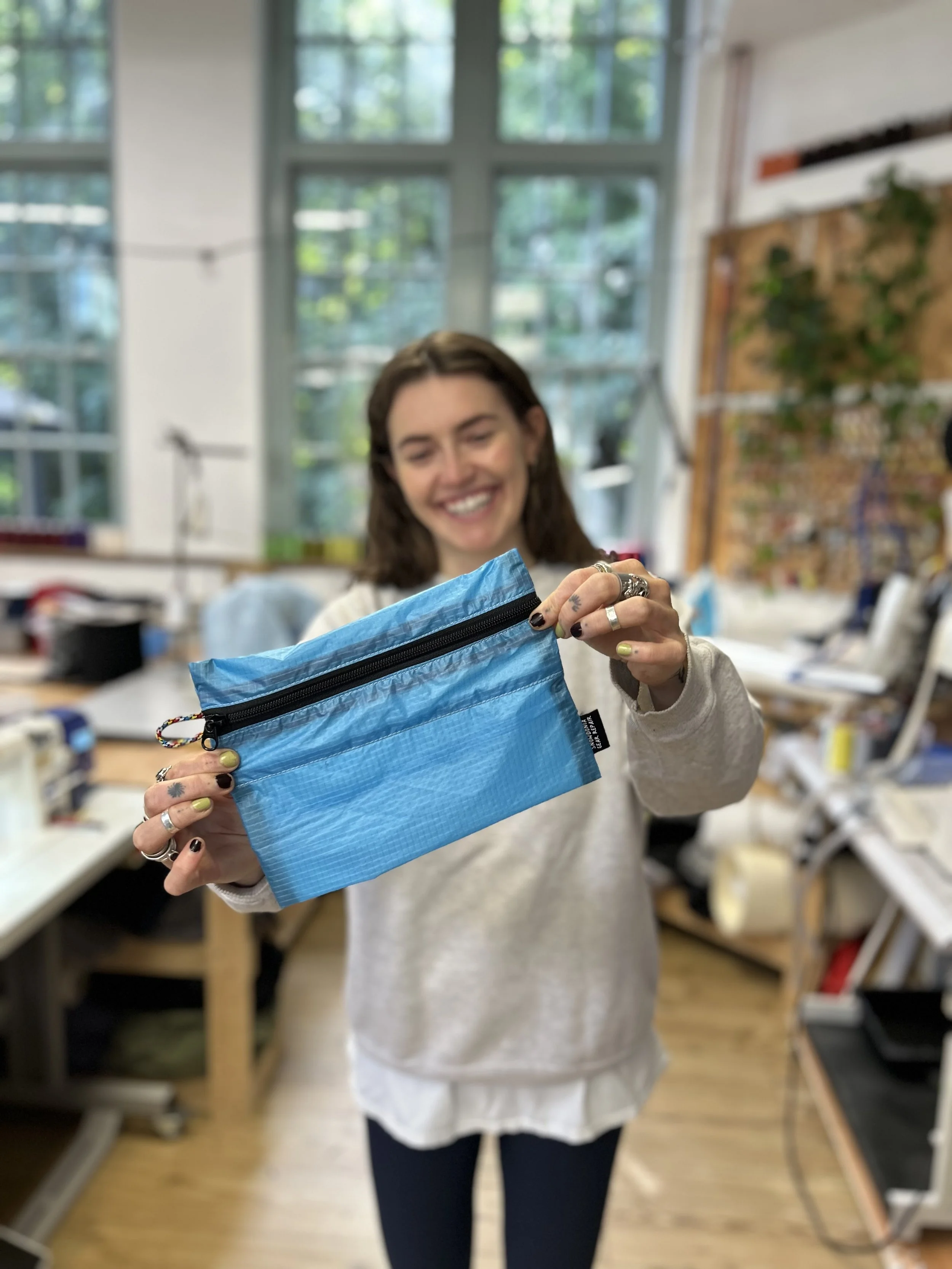 smiling-person-showing-paraglider-zip-wallet.jpeg
