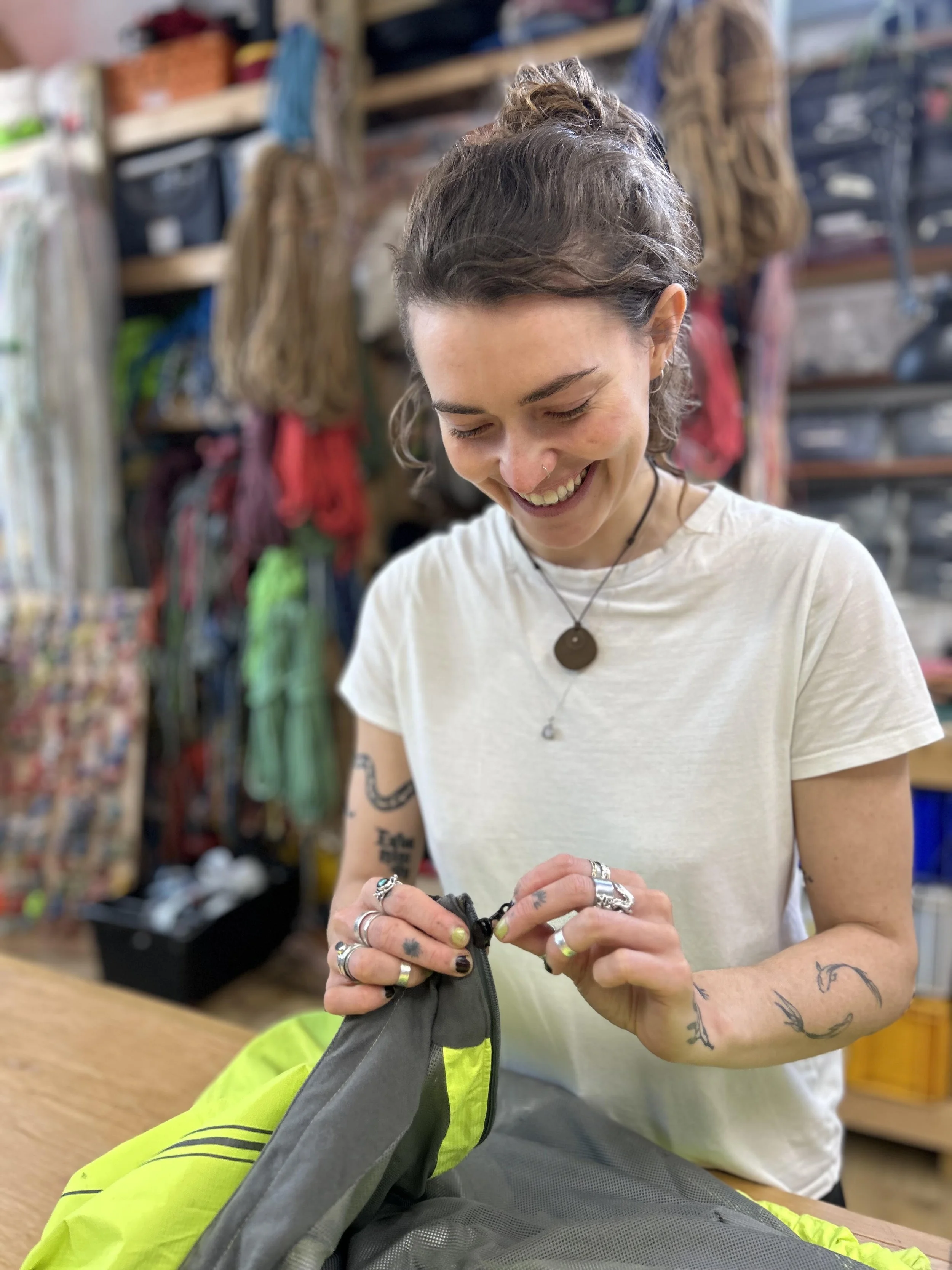 person-happily-fixing-zip-slider-in-how-to-workshop.jpg