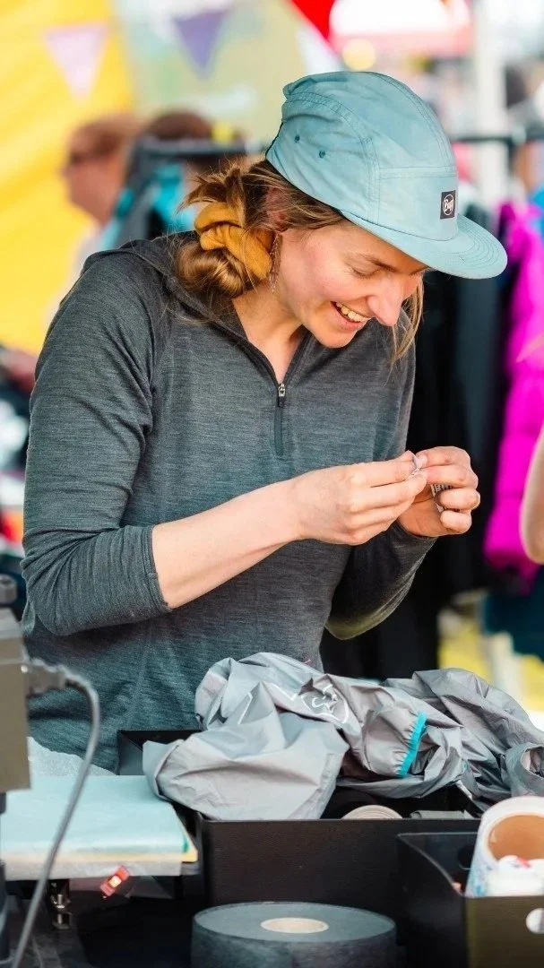 person_fixing_broken_waterproof_jacket.jpg