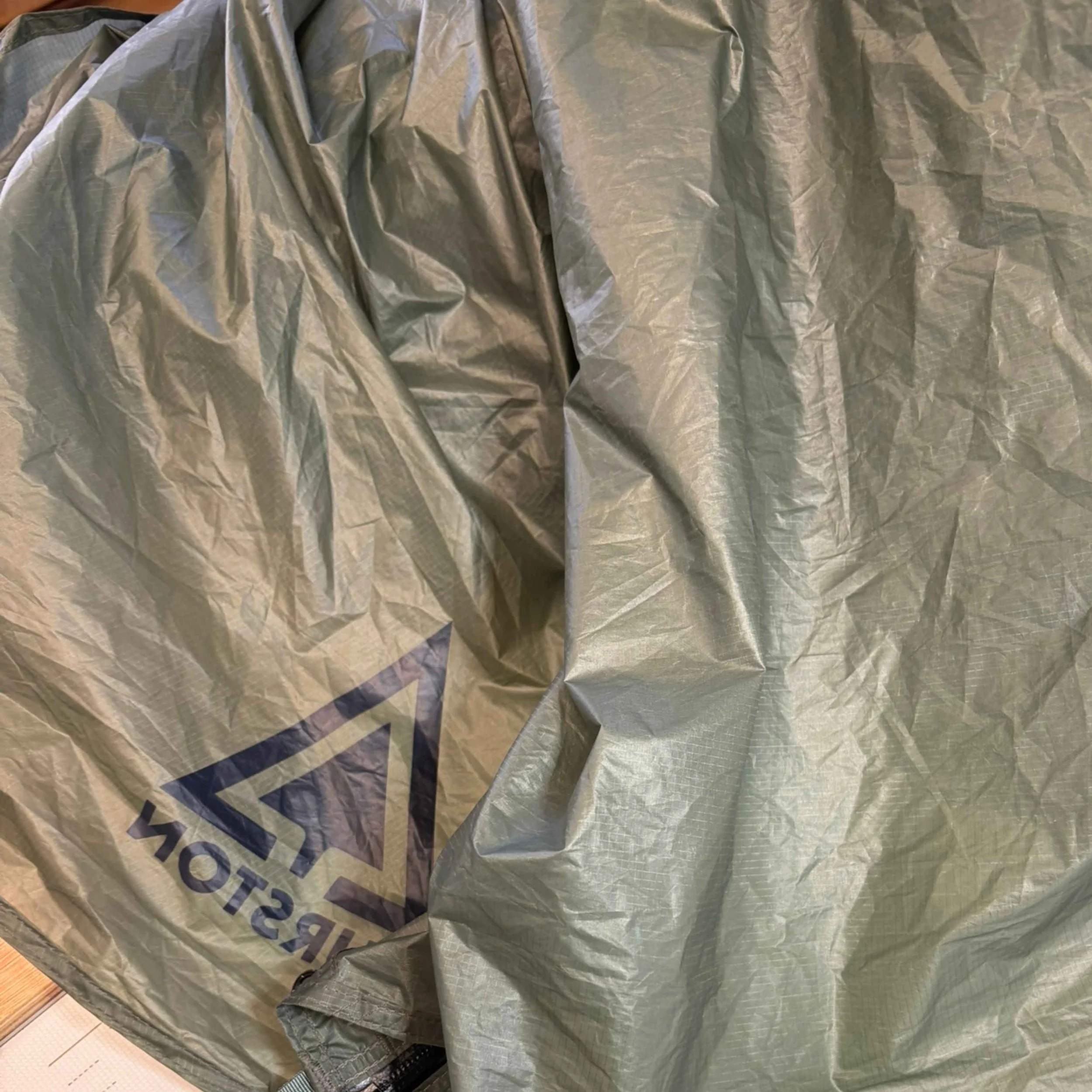 a grey tent about to be patched