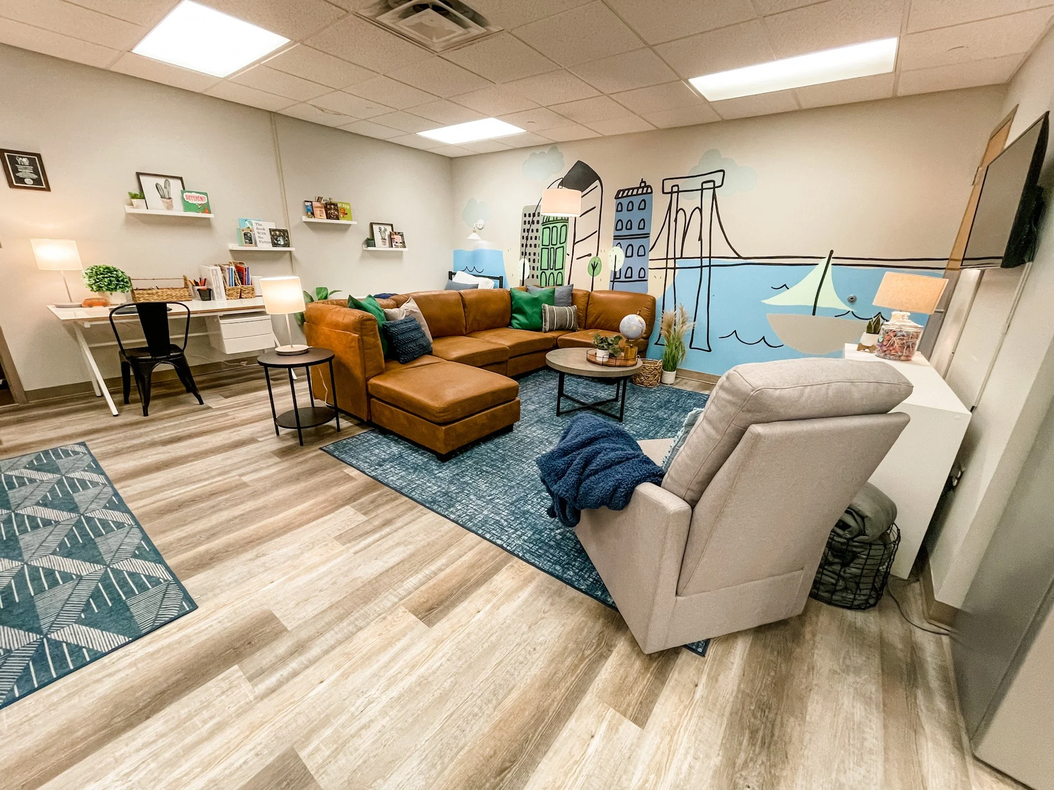 Clearing of the room, wall mural, paint, and flooring were all completed by a community group of volunteers led by Kieran Hooker. Wall mural by Kelsey Bush. 