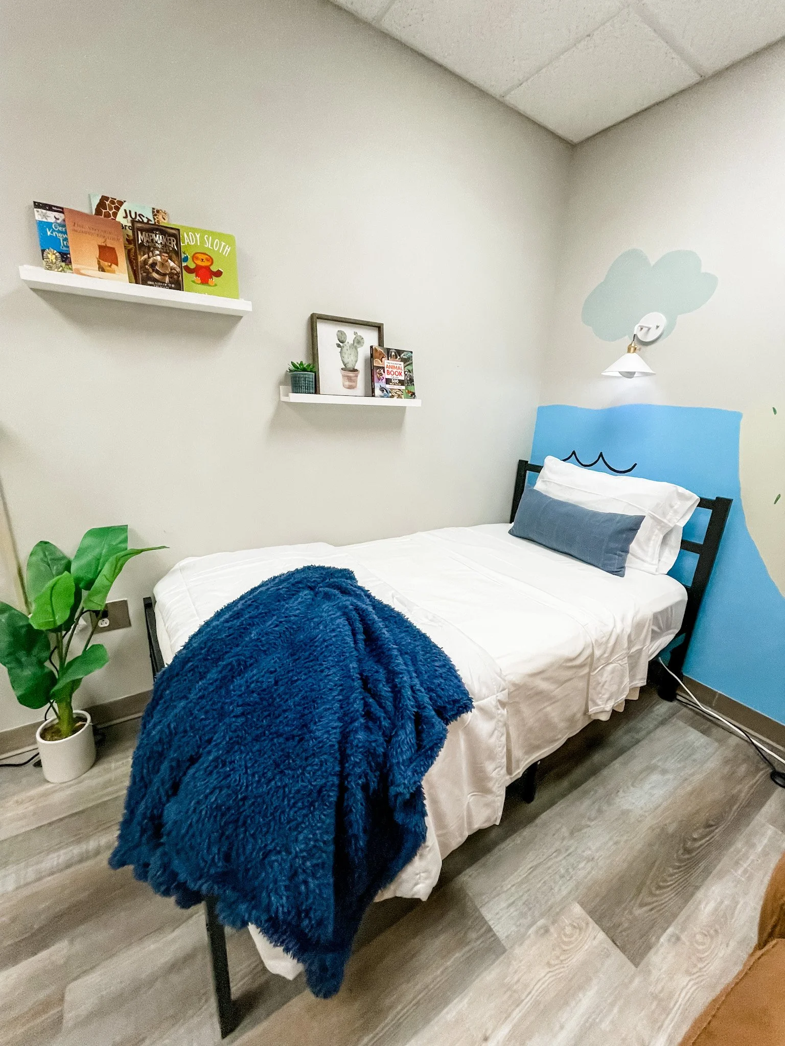 Offices are not meant for sleeping, but due to  a shortage of foster homes and the fact that kids often enter foster care in the middle of the night, having a bed in the space ensures kids have a comfortable place to sleep if needed or rest and read 