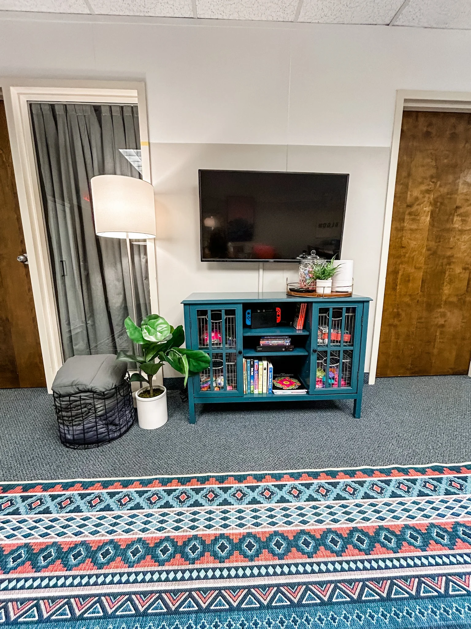 Each side of this 2-in-1 space has a complete entertainment system including TV, bluetooth headphones, Nintendo Switch, BluRay player, Nintendo Switch games, movies for all ages, sensory bin, and toys. 