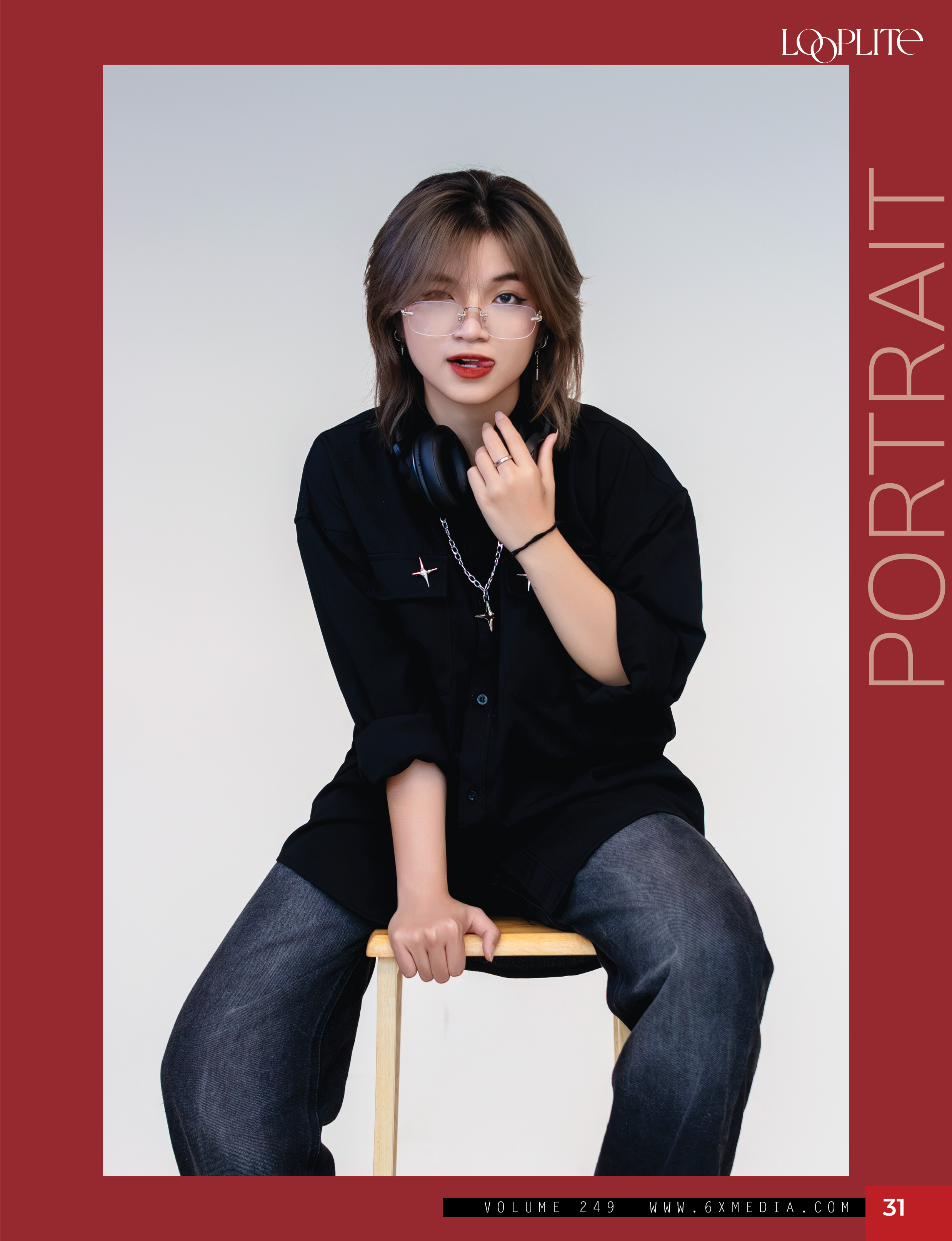 Young woman with shoulder-length brown hair wearing glasses, black shirt, and headphones, sitting on a stool against a plain background.
