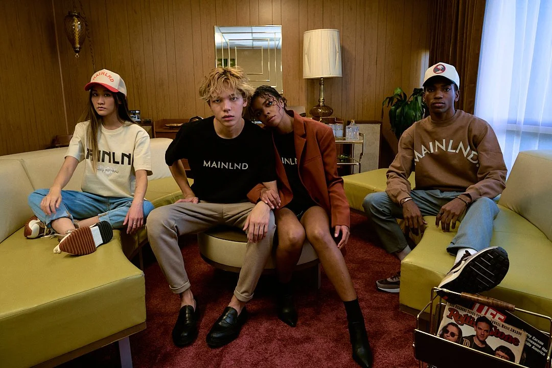 "Logo and merchandise of the MAINLND brand, showcasing stylish apparel and accessories with a modern, urban aesthetic."