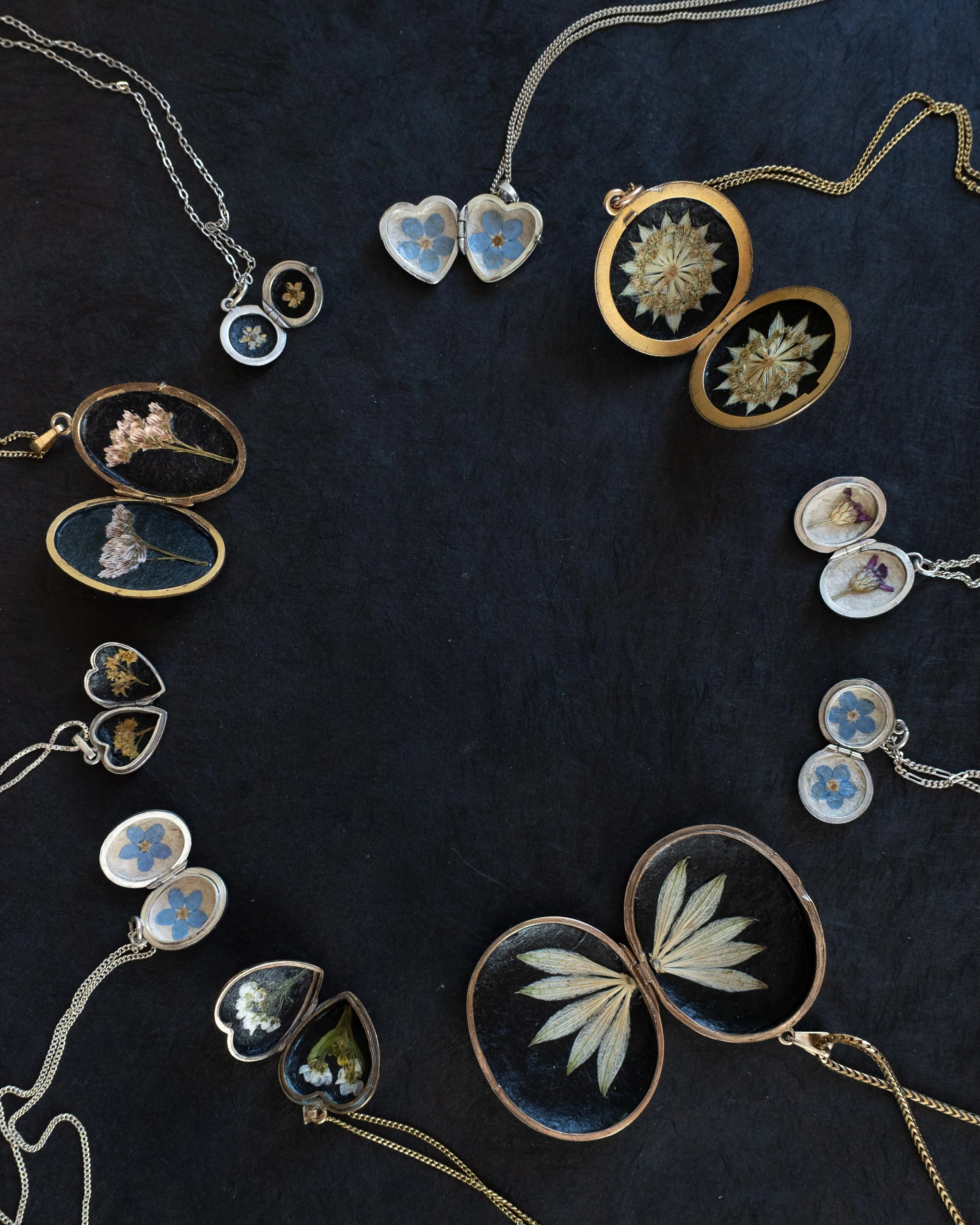 Symbolic pressed flowers encased inside beautiful vintage gold and silver lockets, available on the Meadow and Thyme website now. 🤍