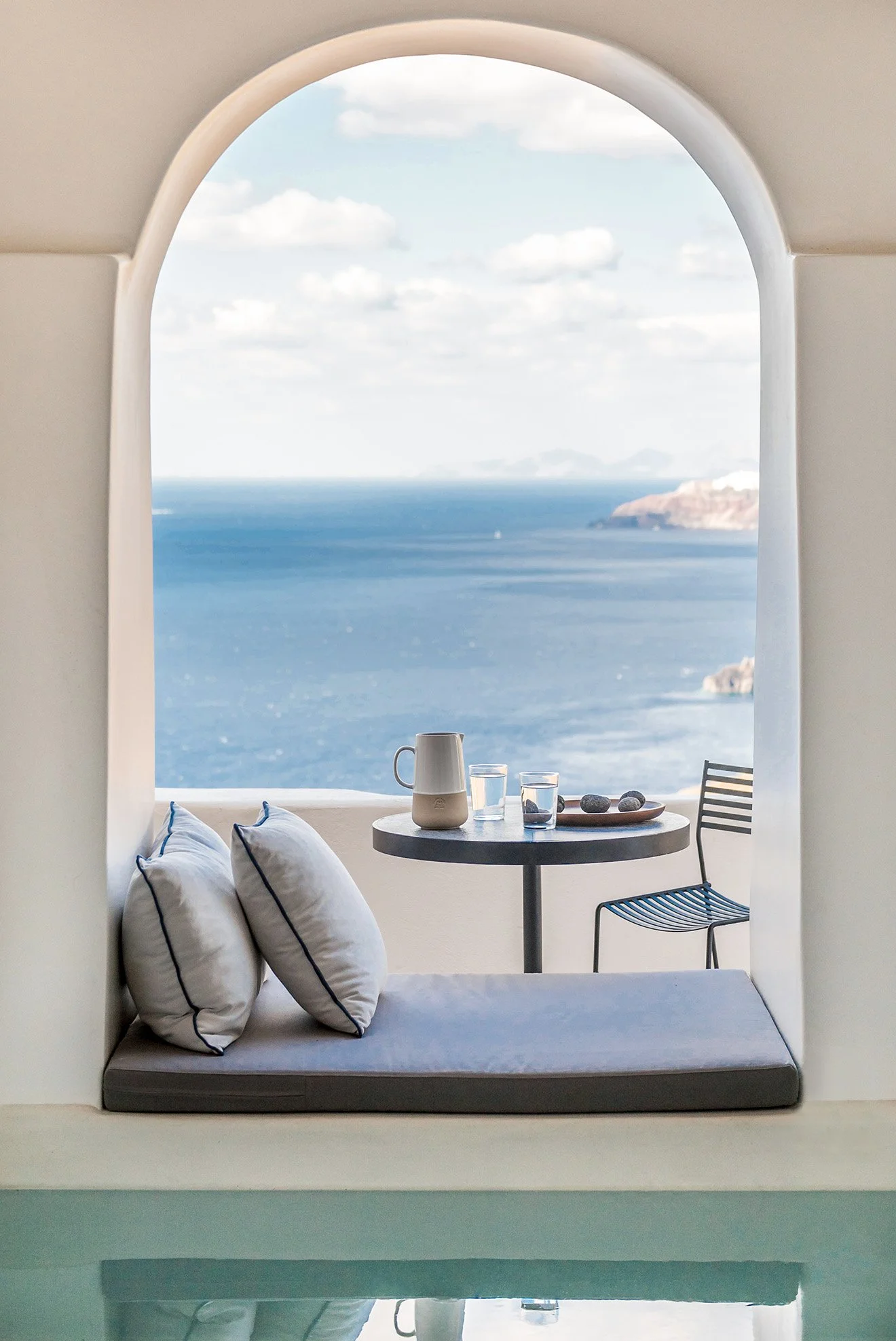 Archway seating with views out across the sea in Santorini by Laboratorium Porto Fira Suites.jpg