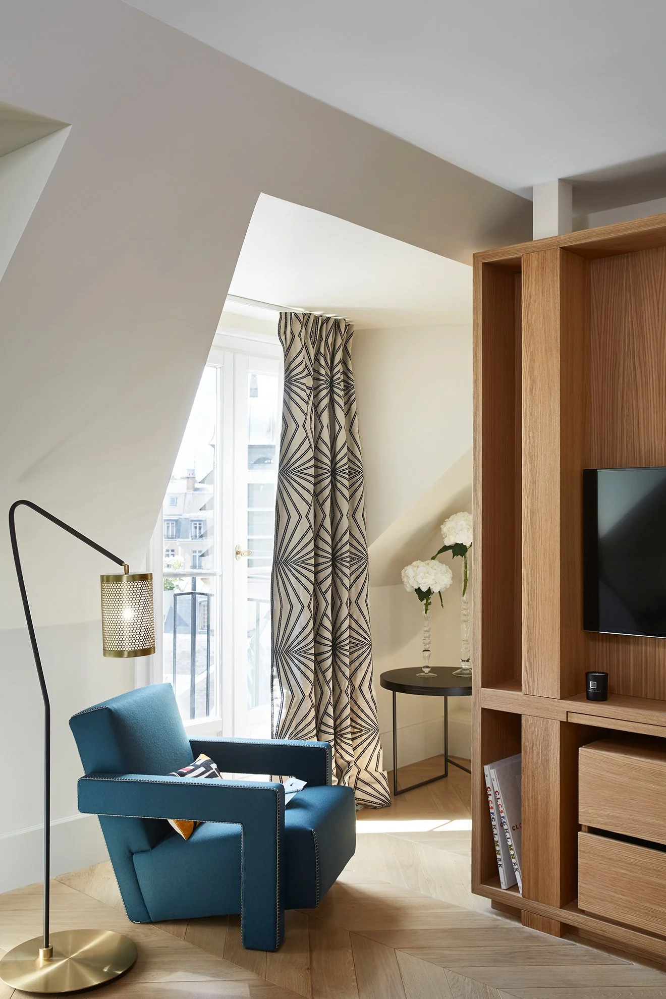 Hotel Montalembert suite with blue upholstered chair and brass floor lamp.jpg