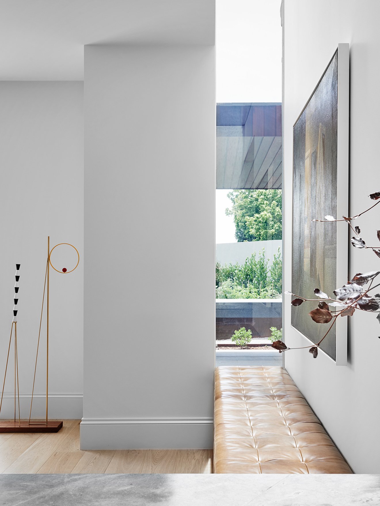 Robson Rak Interior Design hallway with leather upholstered seat and views to the garden.jpg