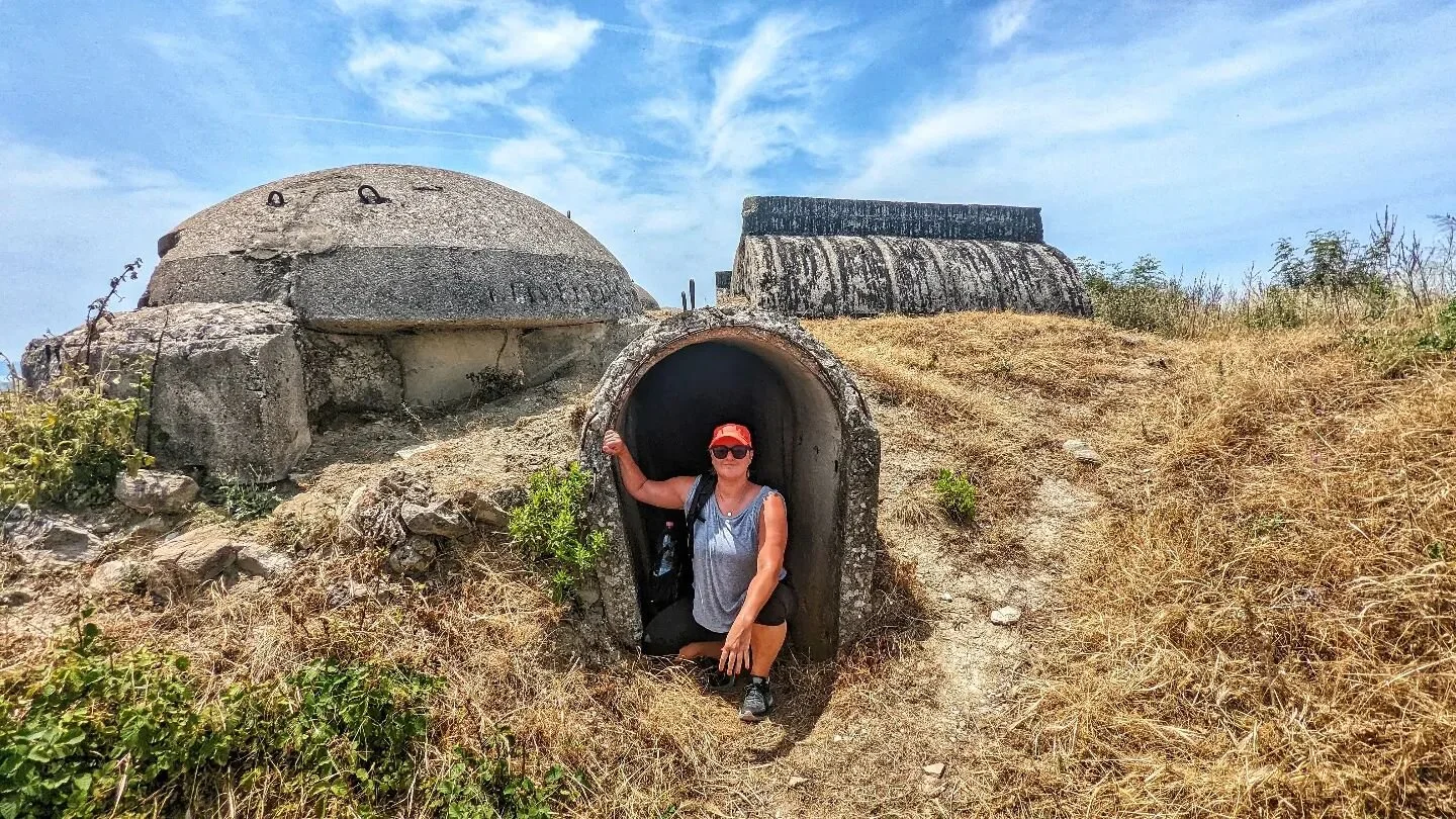 Climbing out of an Albanian bunker complex that we unexpectedly found at the ruins of the ancient city of Phoenike. 

The site had a total of 2 Google reviews, so we took a chance on it - and it was fascinating.. and, we had the entire 5km site to ou