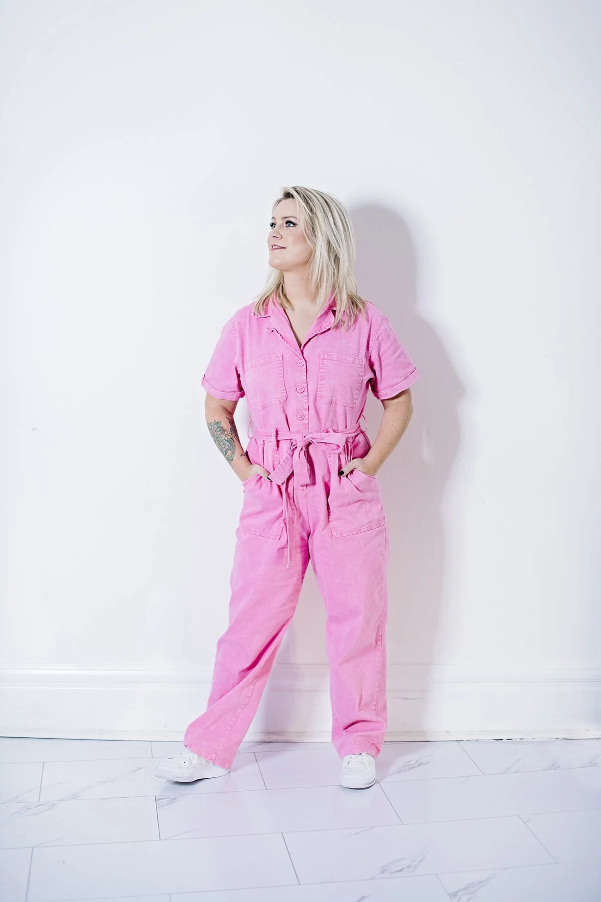 An editorial-style portrait of a young professional, using color and posture to communicate confidence and personal style.