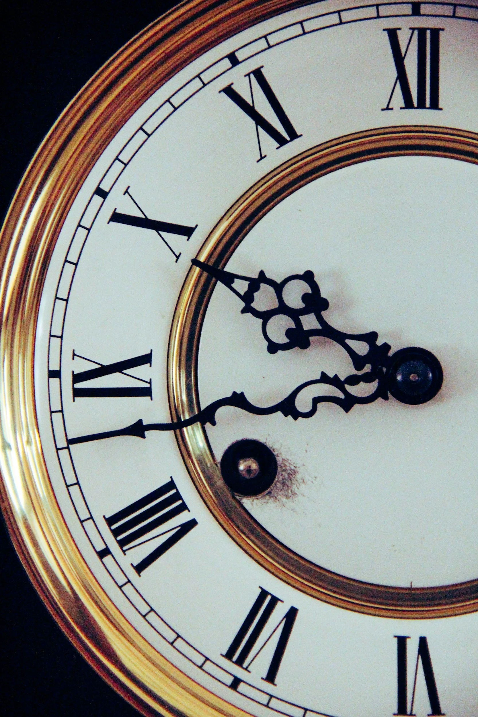 Close-up of a vintage clock showing the time as 10:46.