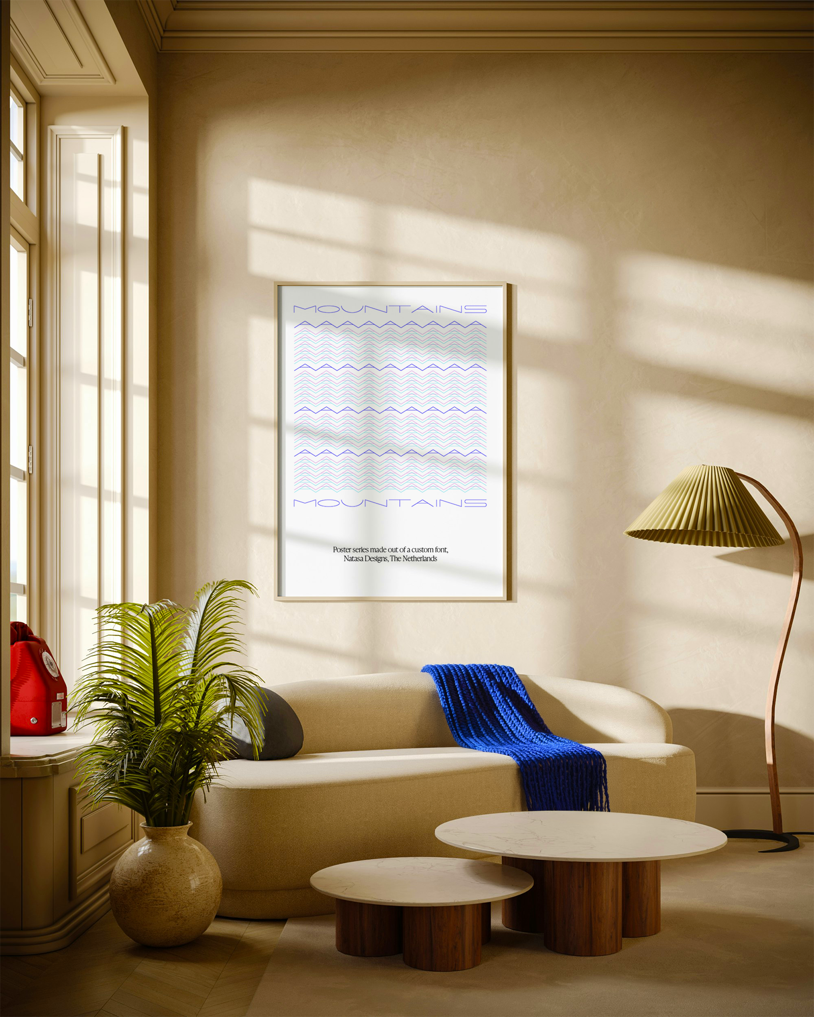 Cozy living room with beige sofa, blue knitted throw, potted plant, round marble-top coffee tables, standing lamp with green pleated shade, framed art print titled 'Mountains' with wave patterns and text in a bright sunlight-lit room.