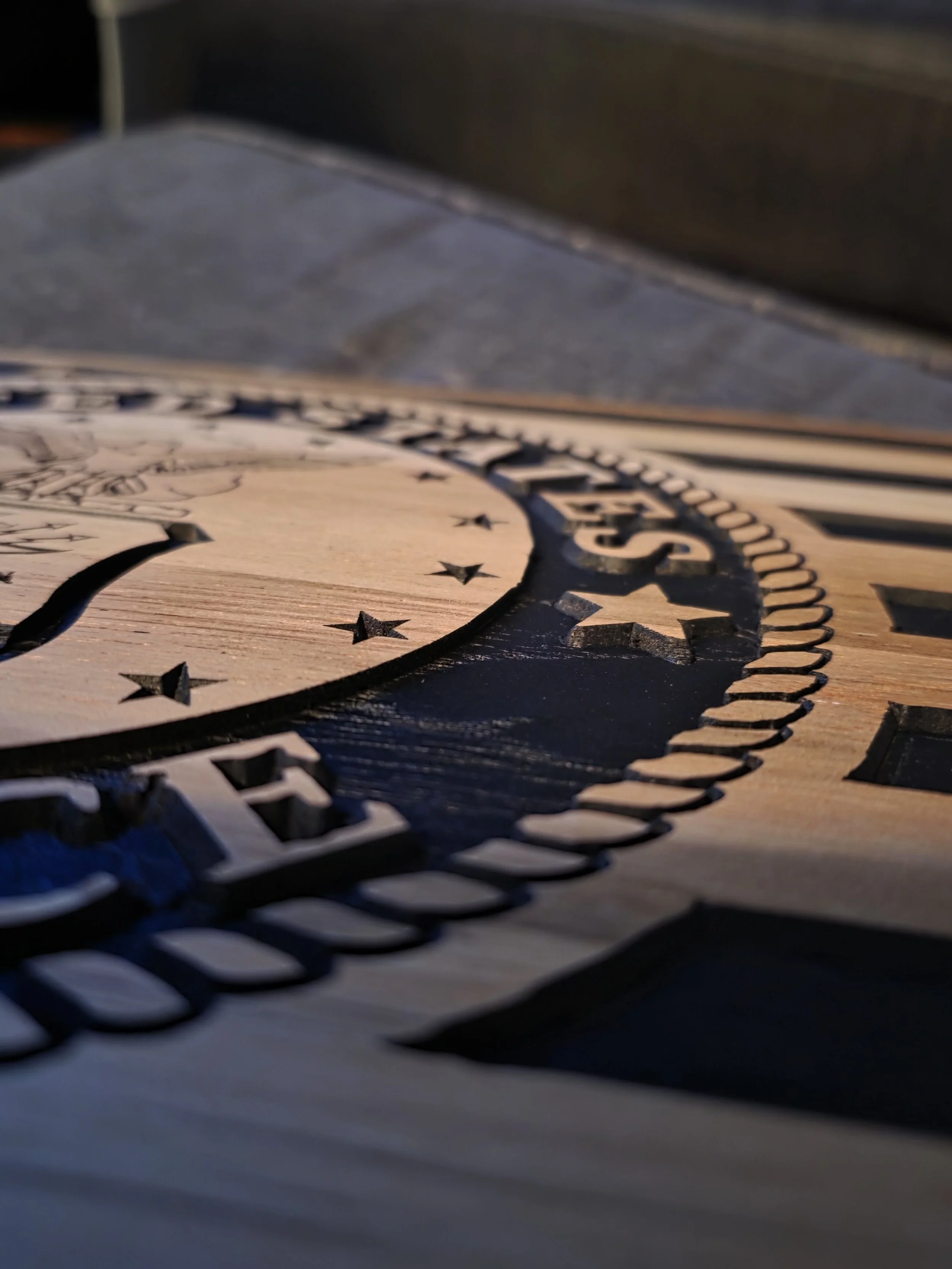 Close-up of Air Force seal CNC carving showing raised detail and pocketed background