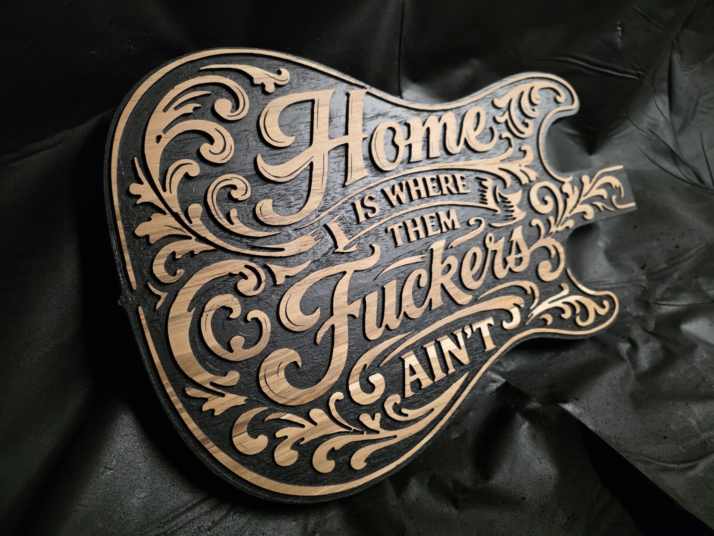 Close-up of V-carved lettering and detail work