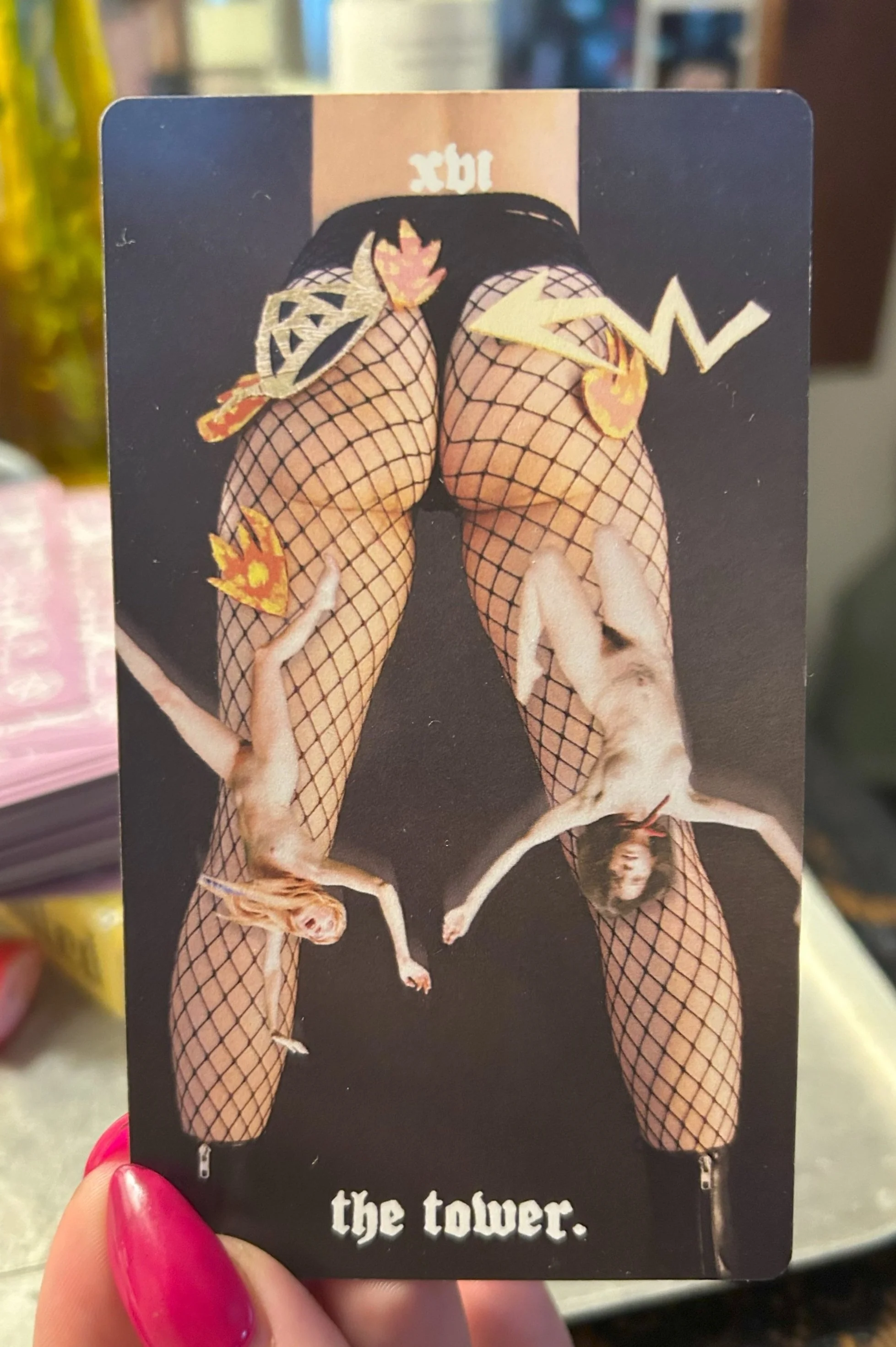tarot card the tower women's legs in fishnets upside down women falling flames long nails pink tarot deck